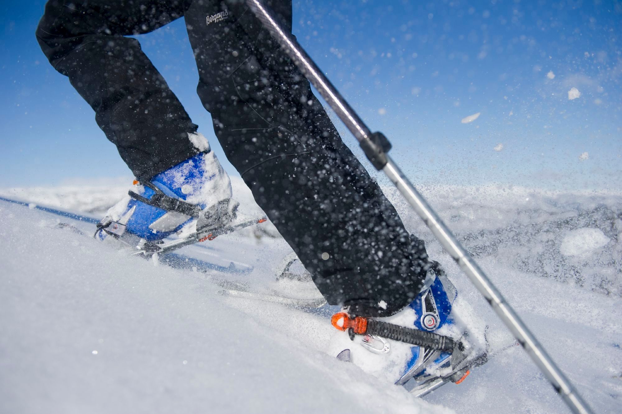 The legs of someone ski touring in the mountain