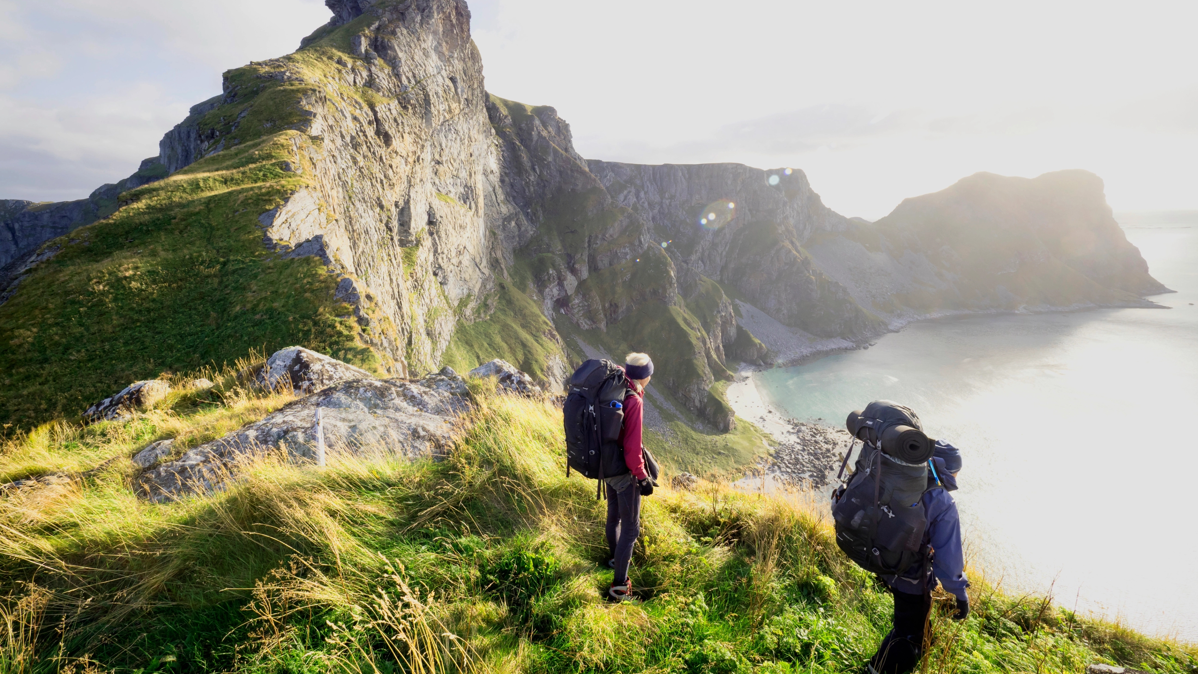 Two people hiking in Værøy in the Lofoten Islands in Northern Norway