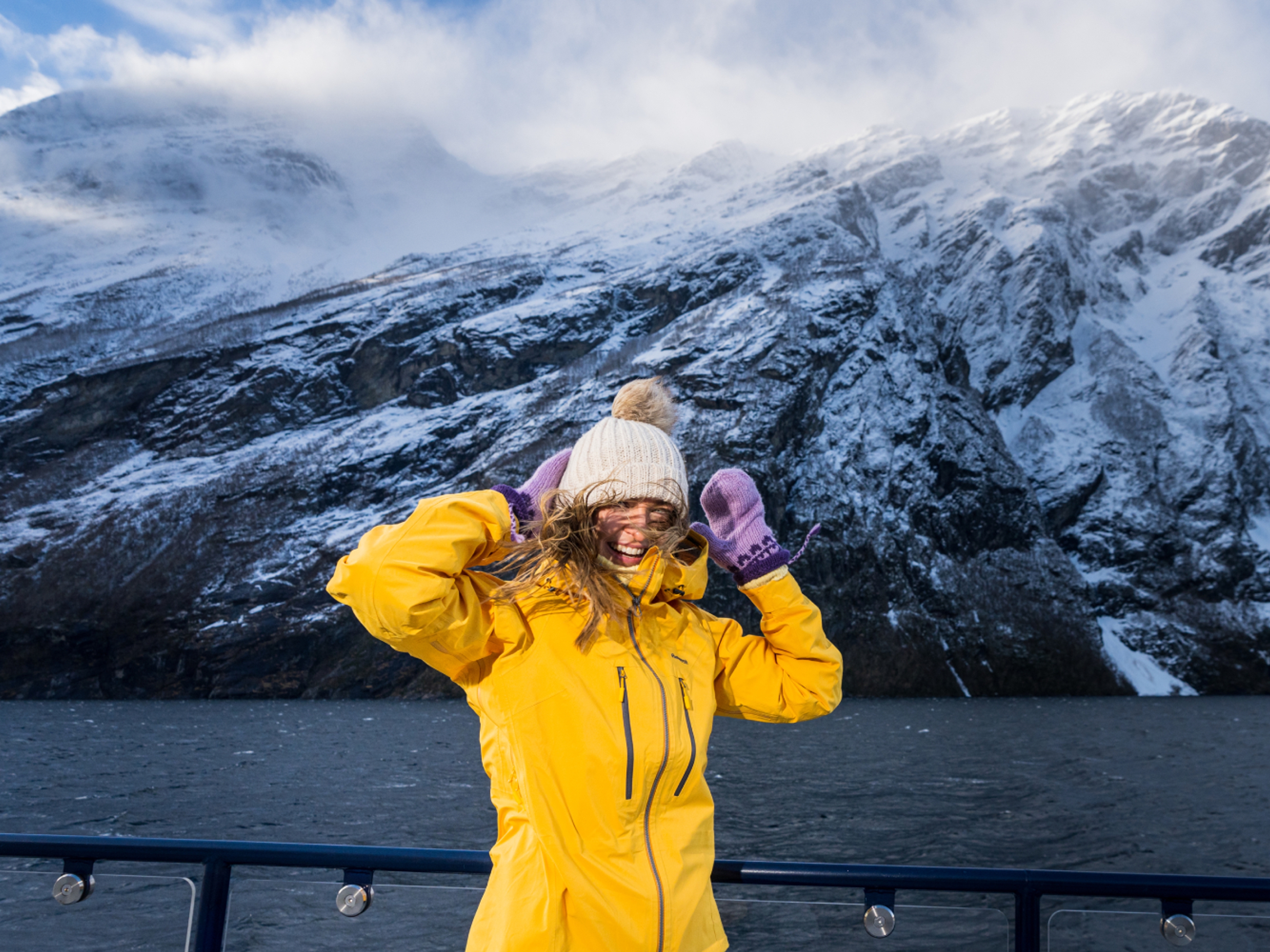 Woman on top of the sightseeing boat from Ålesund to the Geirangerfjord in winter