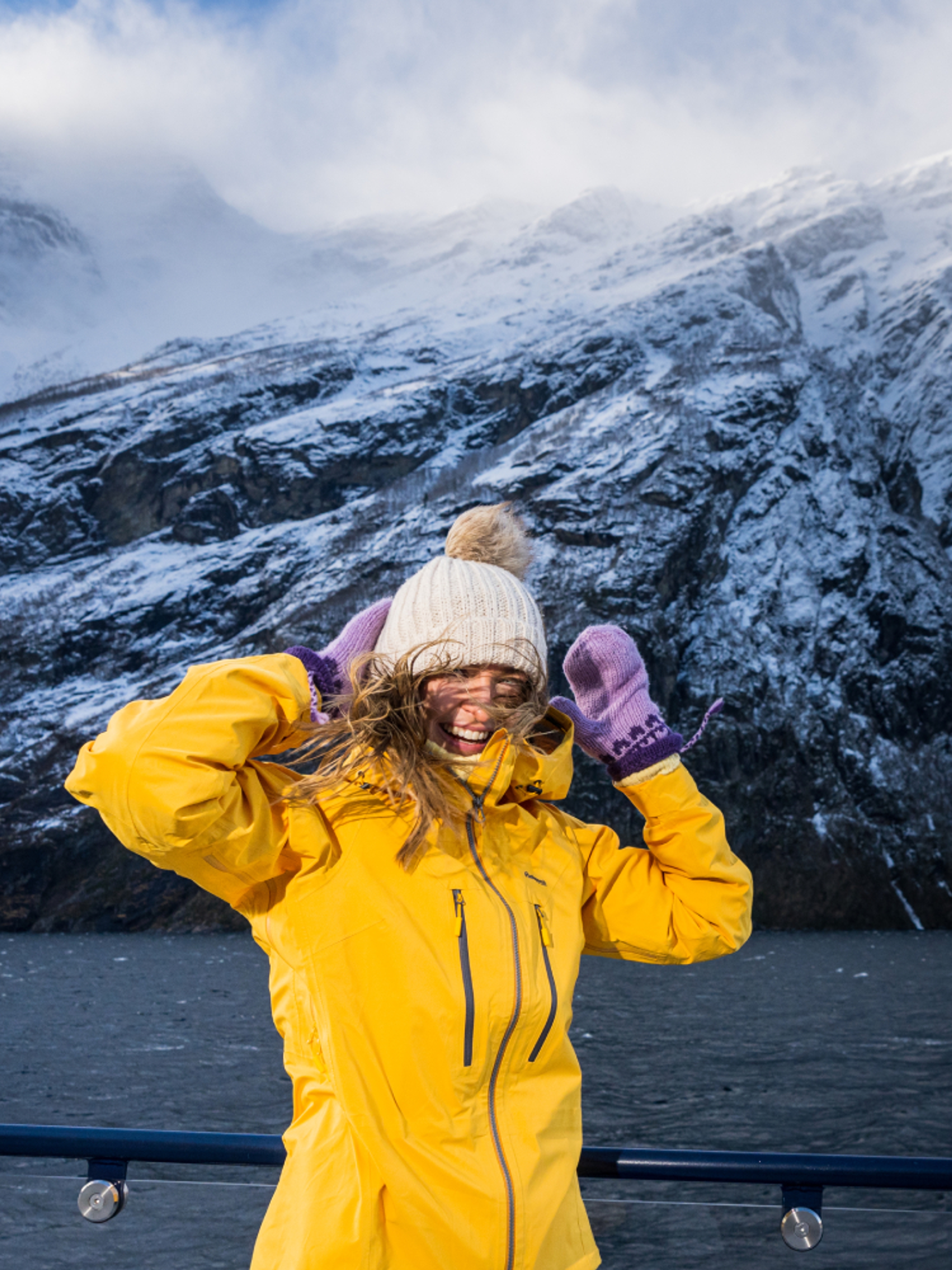Woman on top of the sightseeing boat from Ålesund to the Geirangerfjord in winter