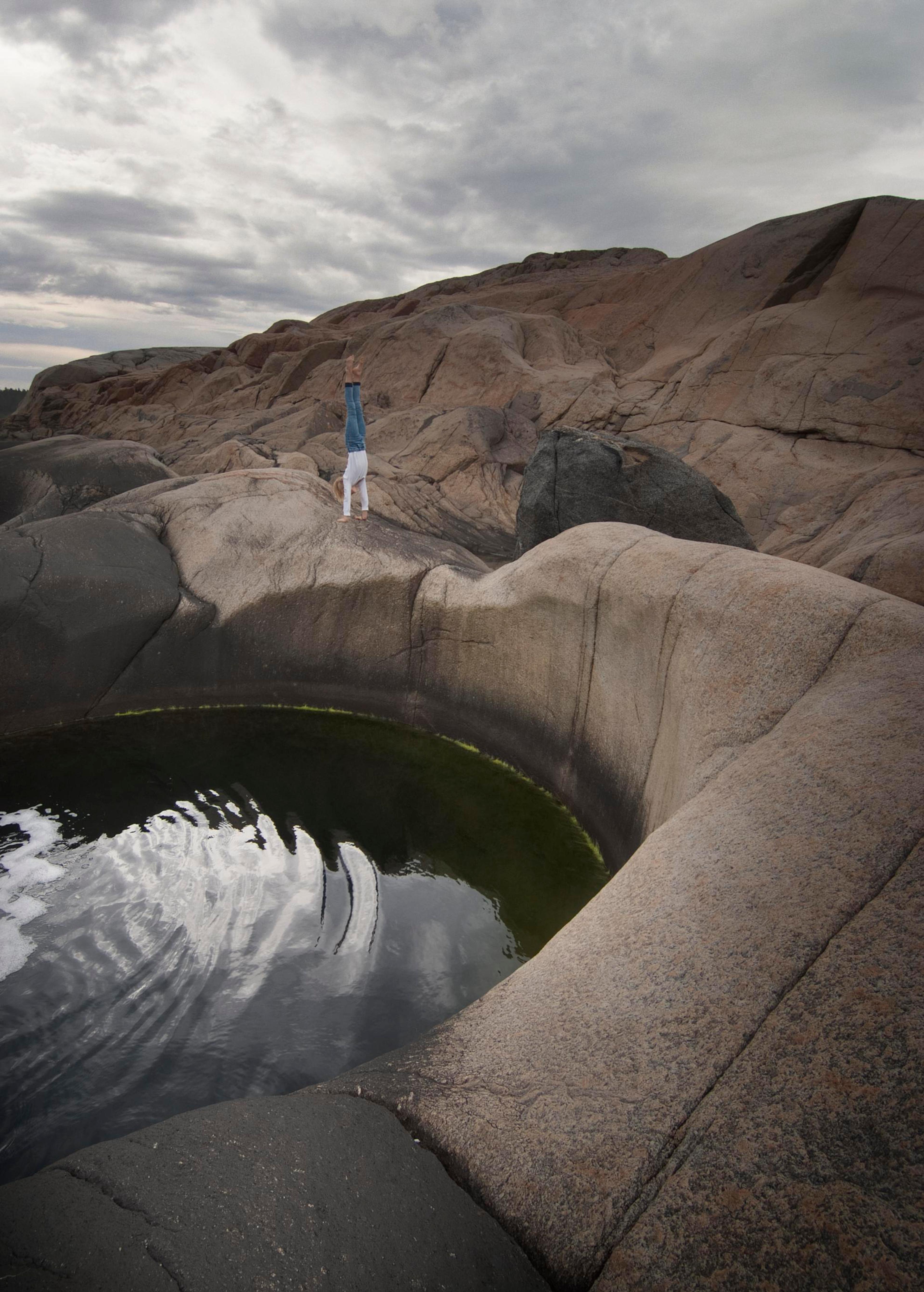 A person standing on the edge of a pothole at Sild in Risør, Southern Norway.