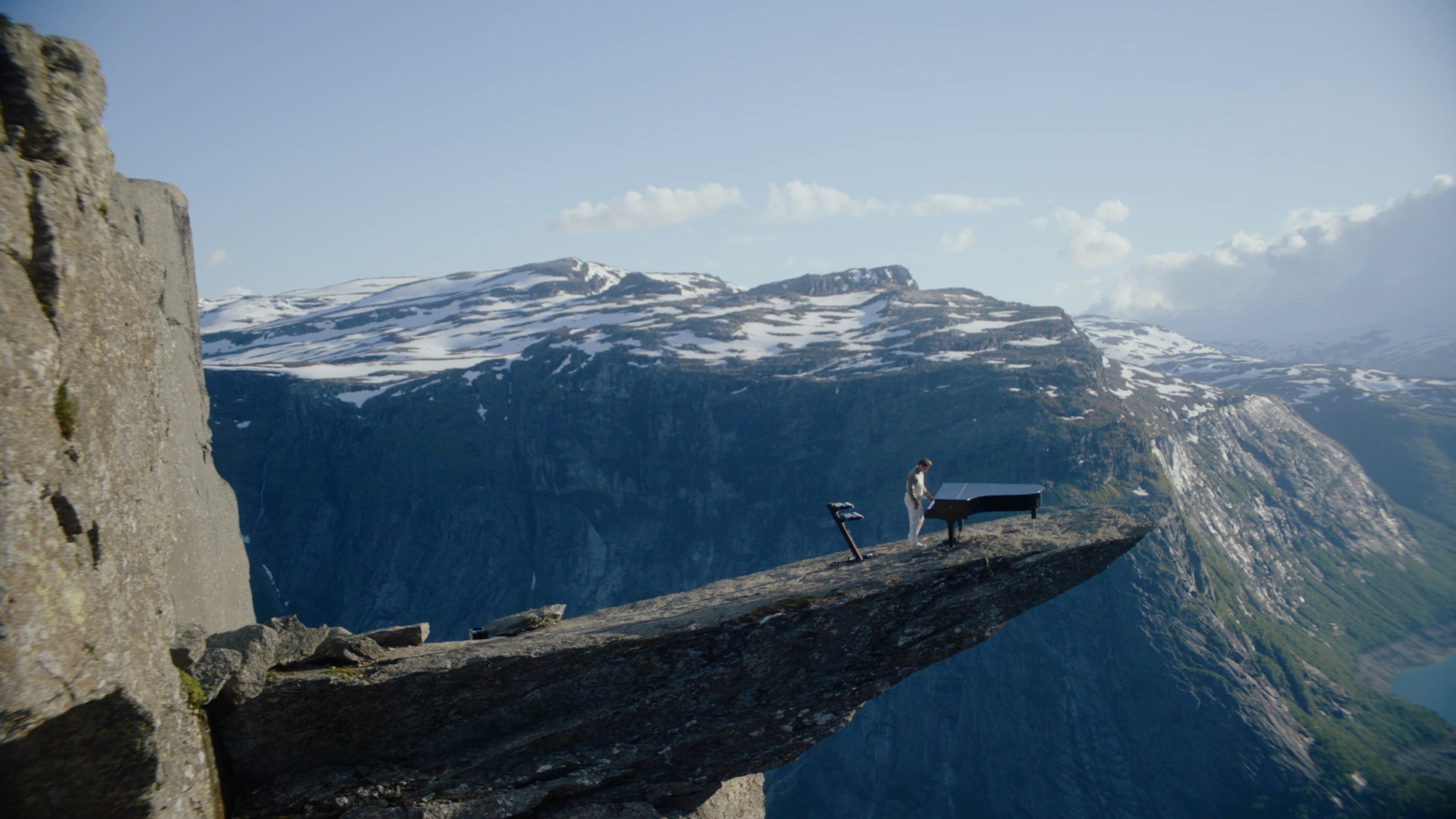 The Norwegian musician Kygo playing the piano on Trolltunga