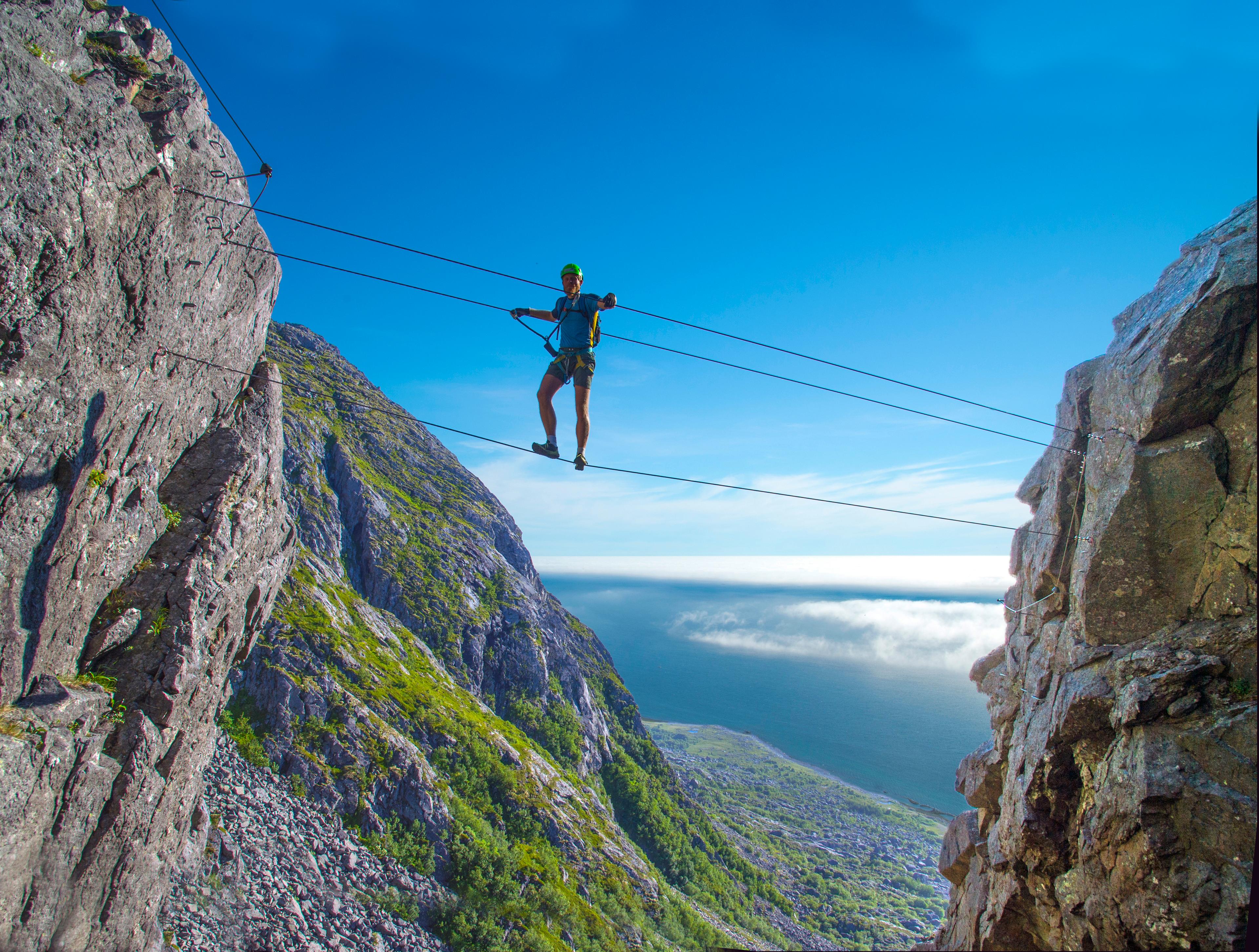 Man climbing the Ravnfloget Via Ferrata in Vega