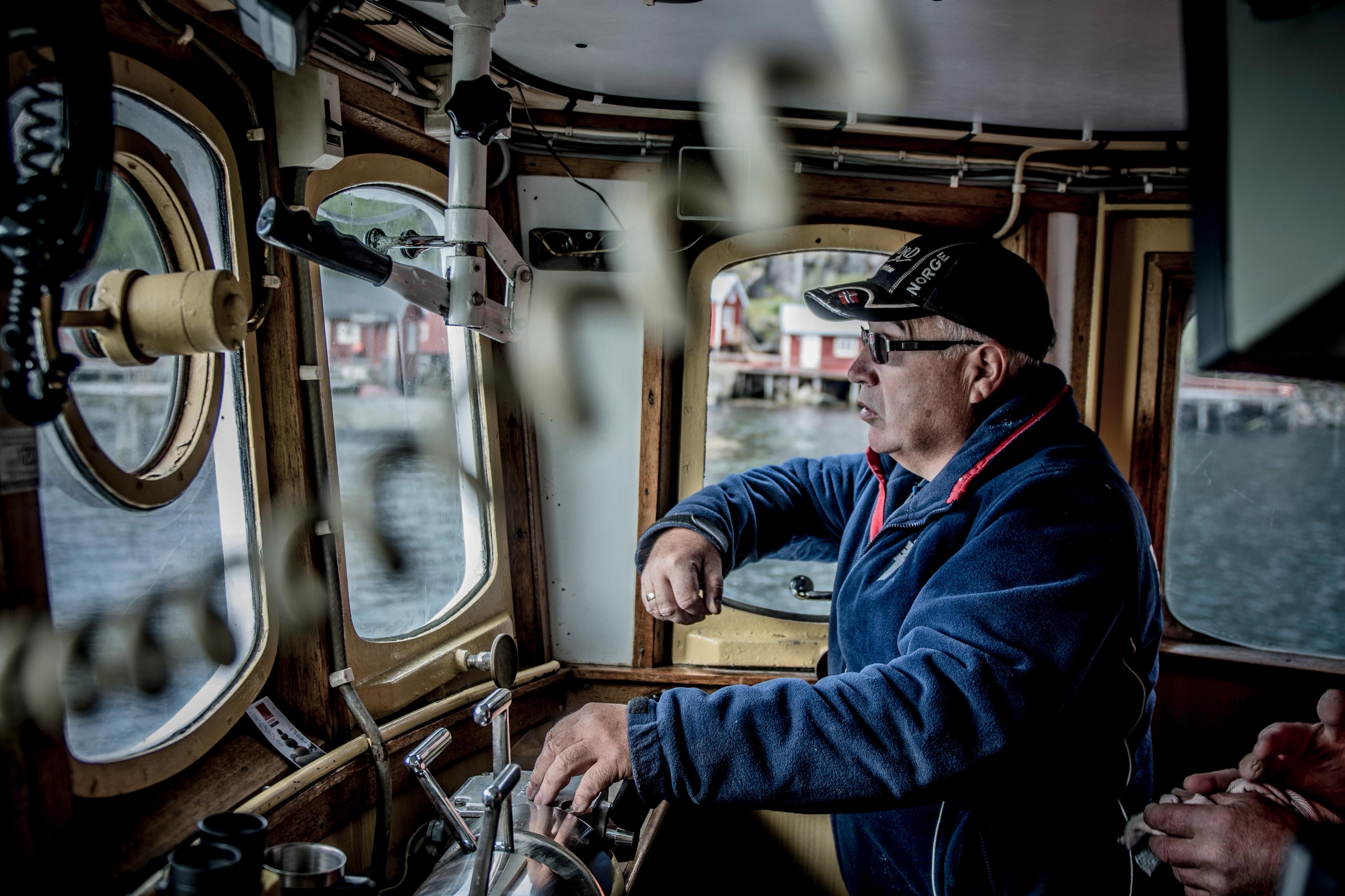 Jan Martin Johansen driving his fishing boat «Elltor» in Nusfjord in Lofoten, Northern Norway