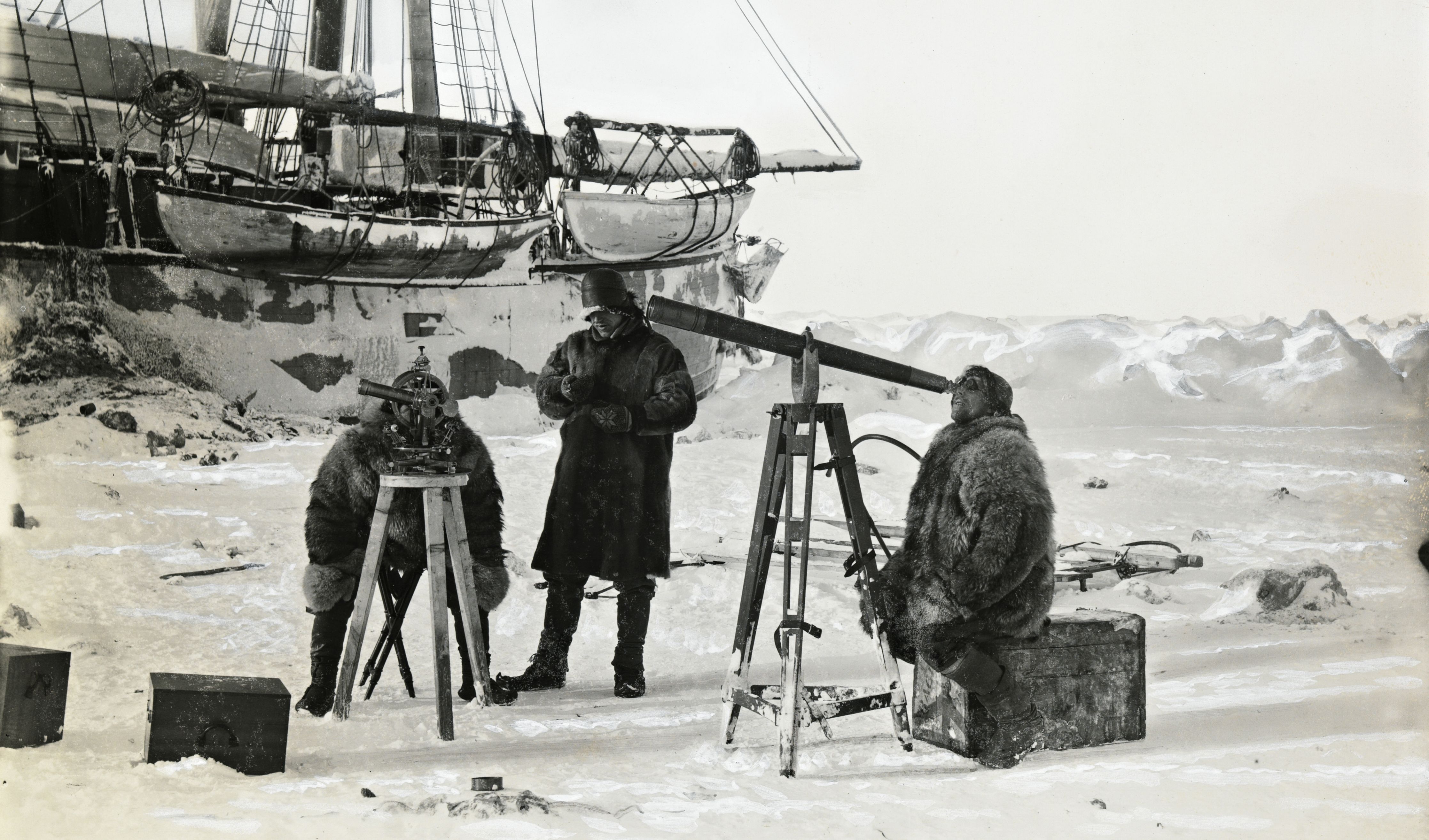 Fridtjof Nansen observing the solar eclipse through a telescope with two of his crew members