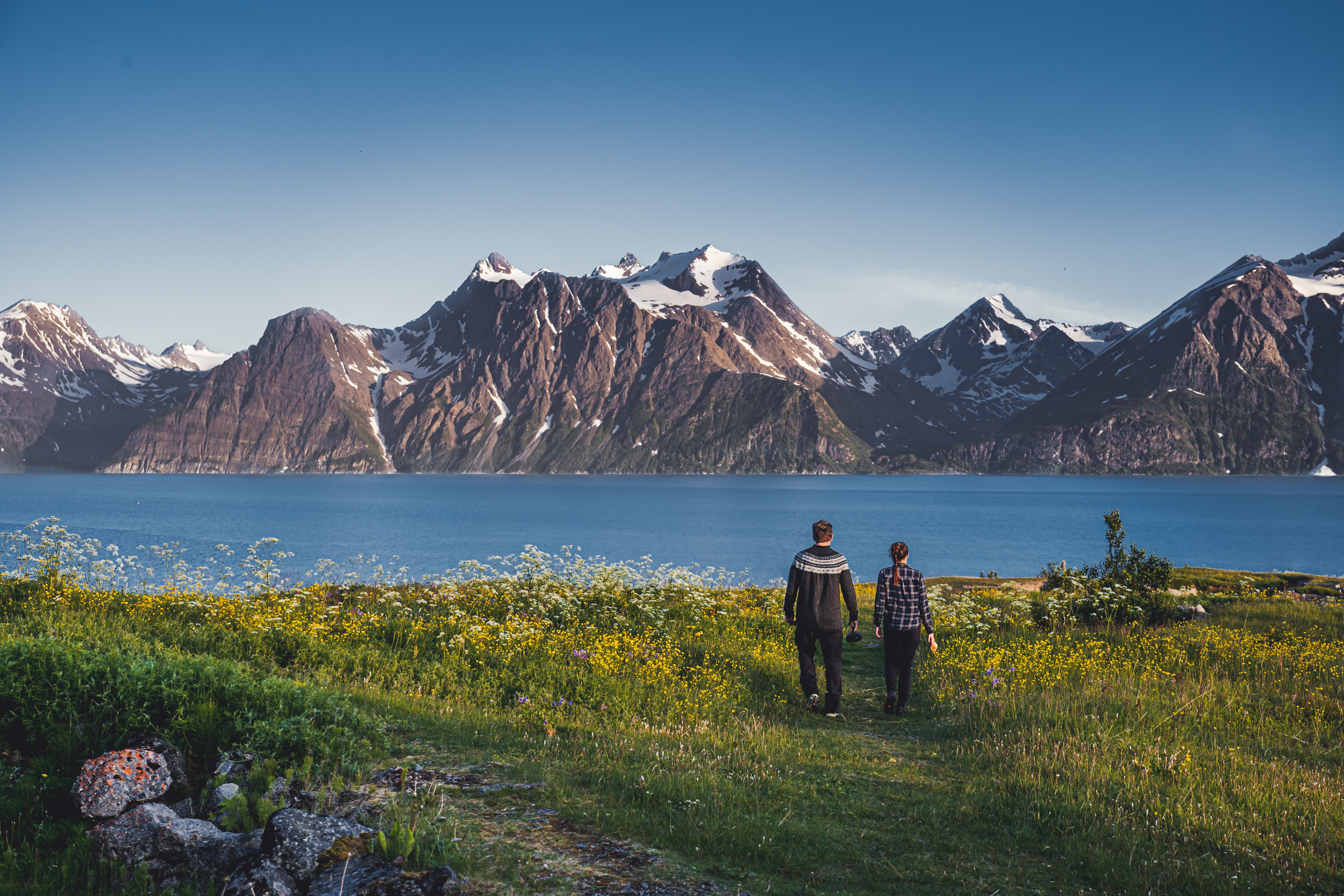 Two people in front of the Lyngenfjord Alps