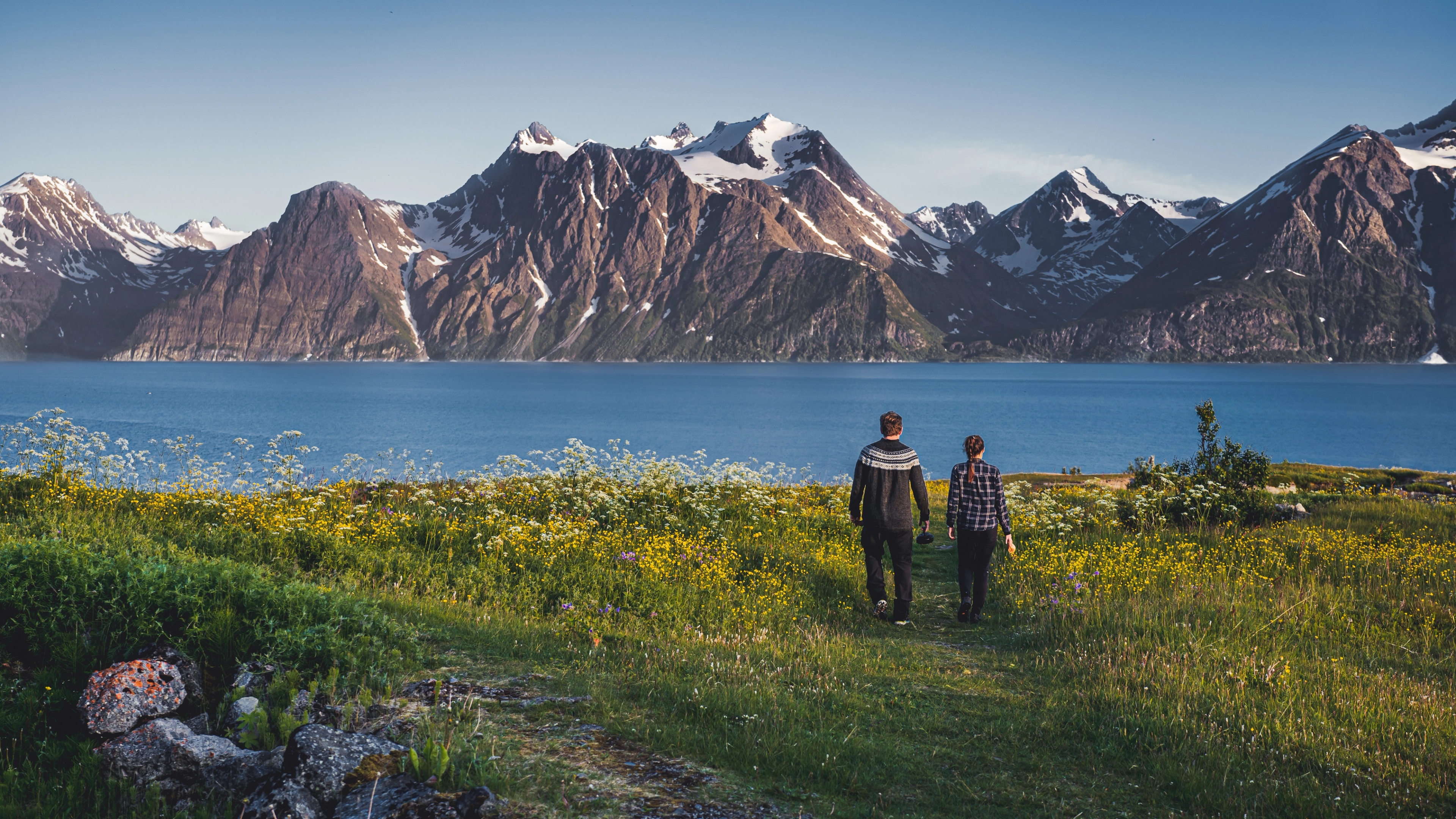 Two people in front of the Lyngenfjord Alps