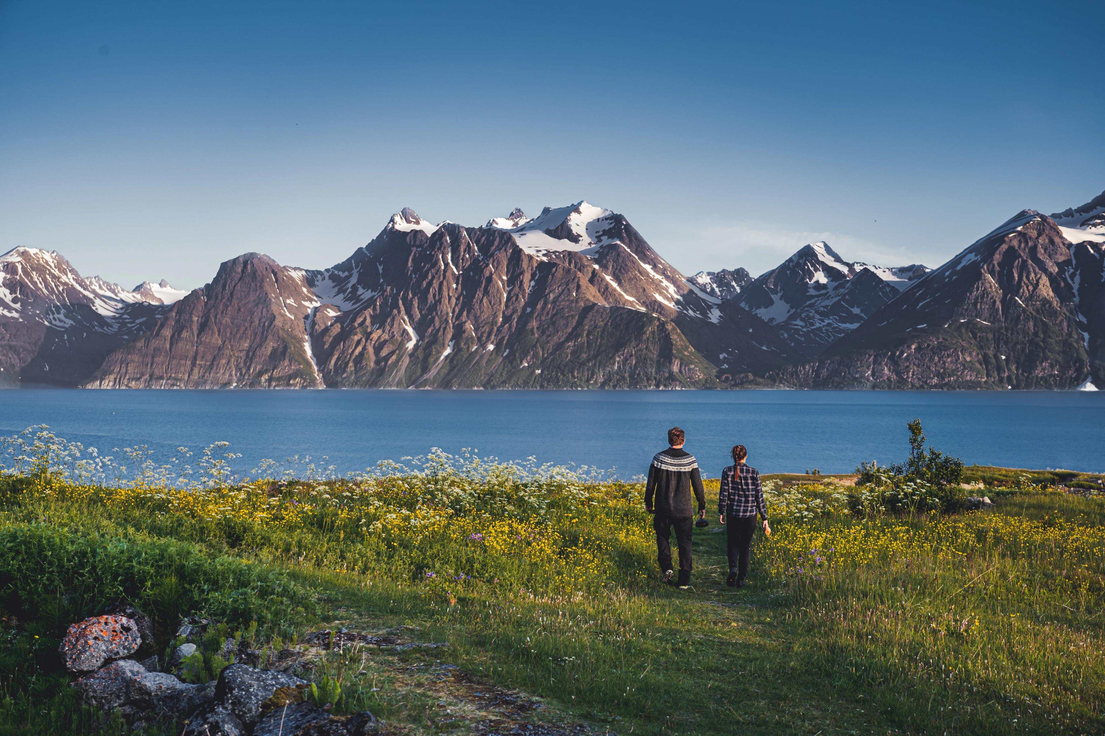 Two people in front of the Lyngenfjord Alps