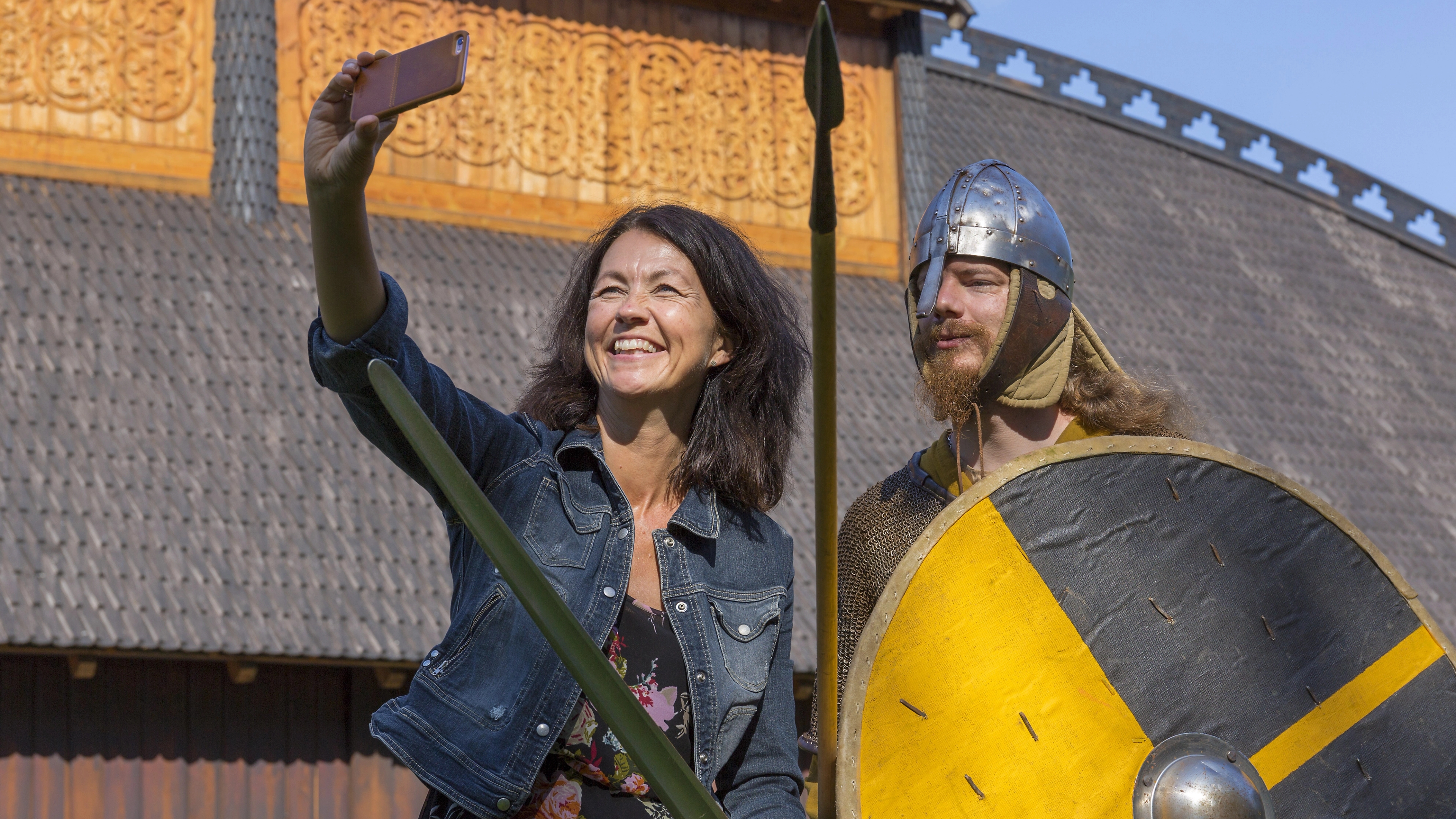 A woman takes a selfie with a Viking at Midgard viking centre in Borre in Vestfold, Eastern Norway