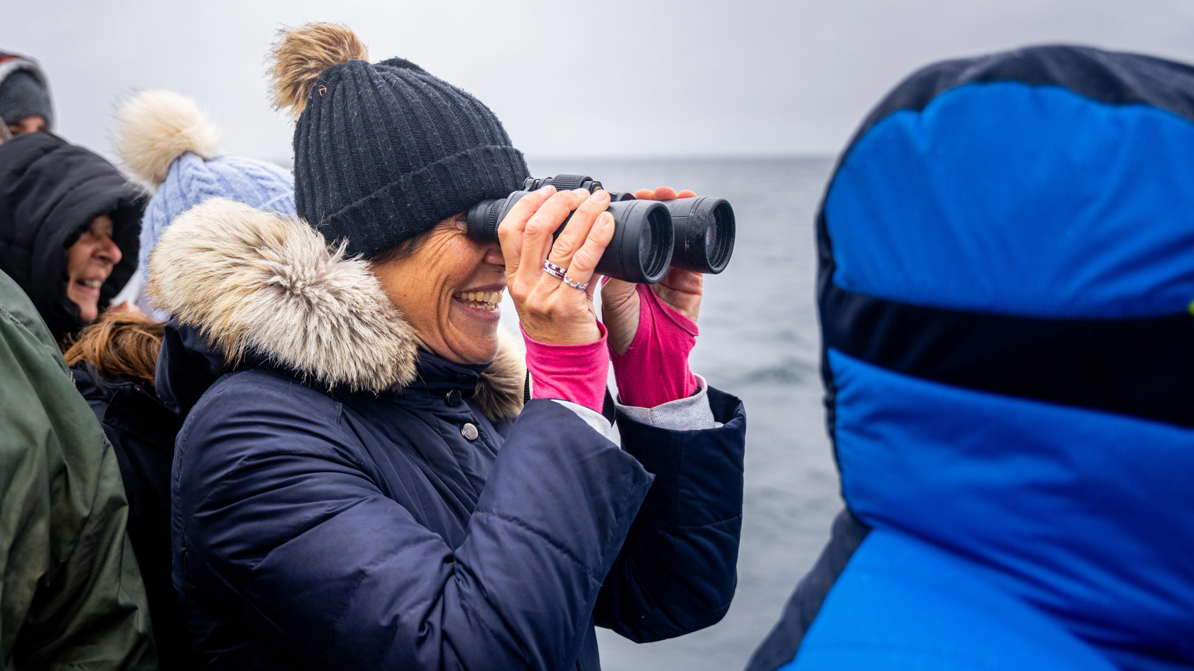 Tourist scouting for whale from the ship, Andenes, Northern Norway