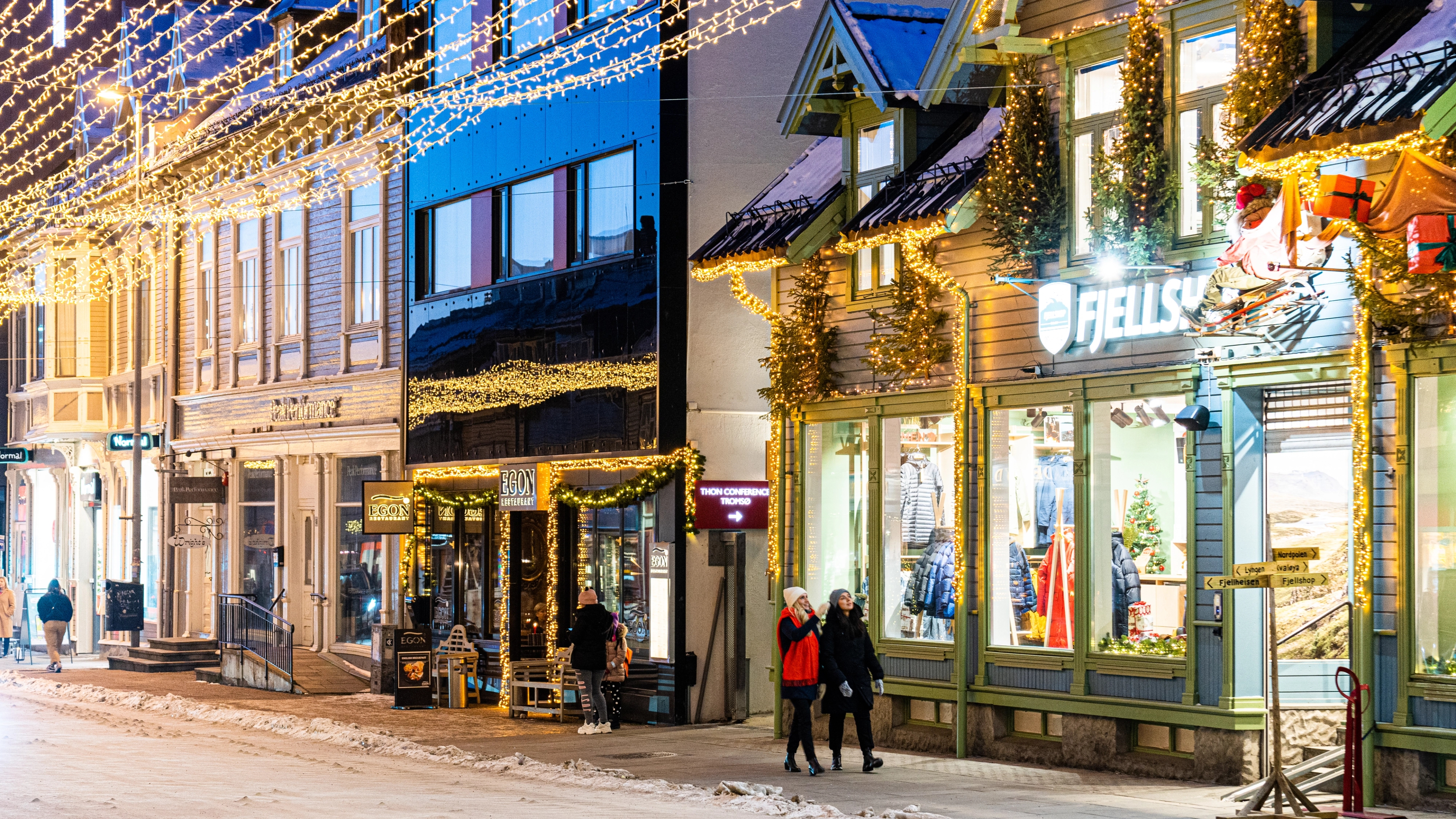 Two girls walking in the Christmas streets of Tromsø