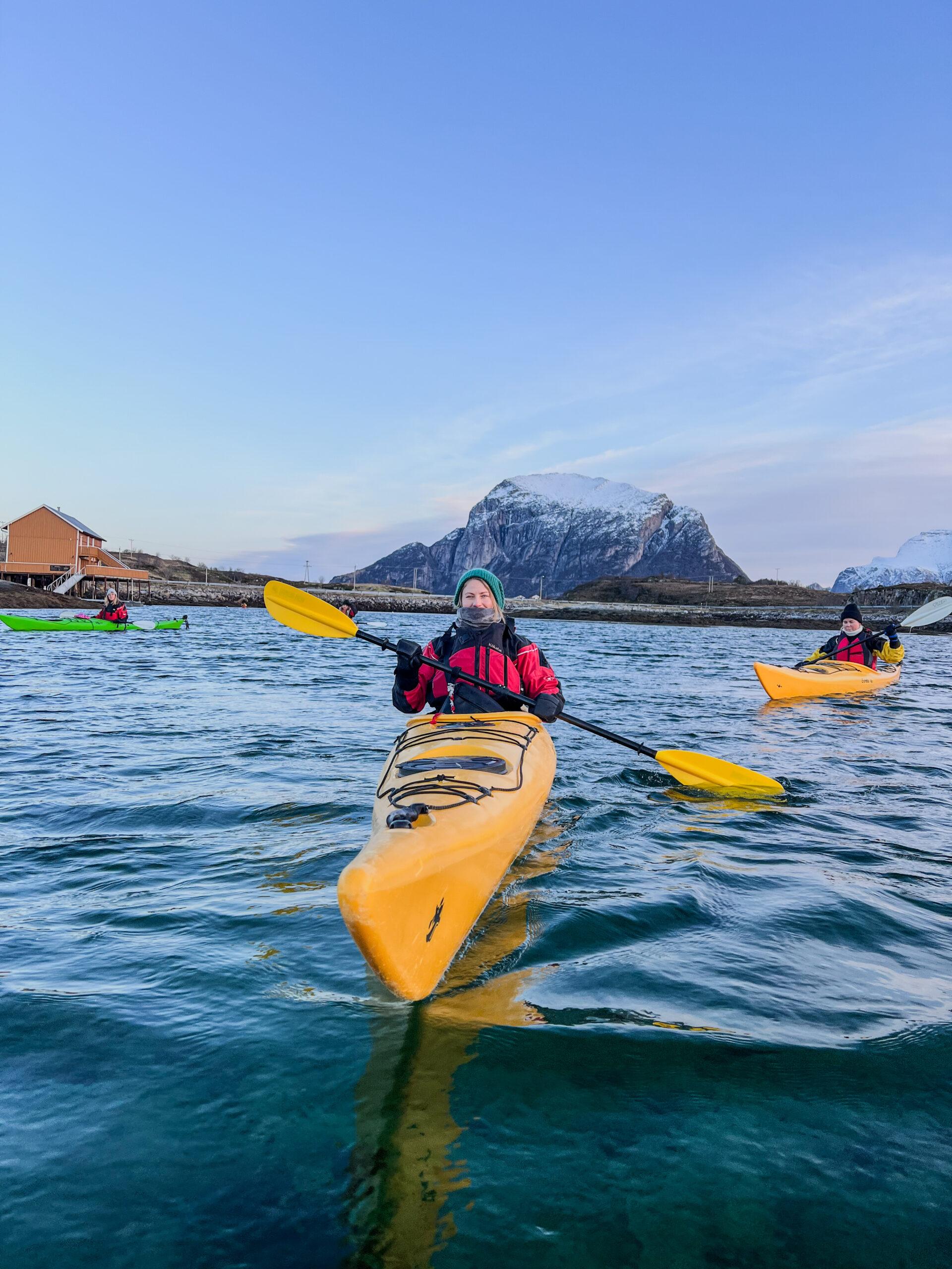 A person kayaking in Northern Norway in winter.