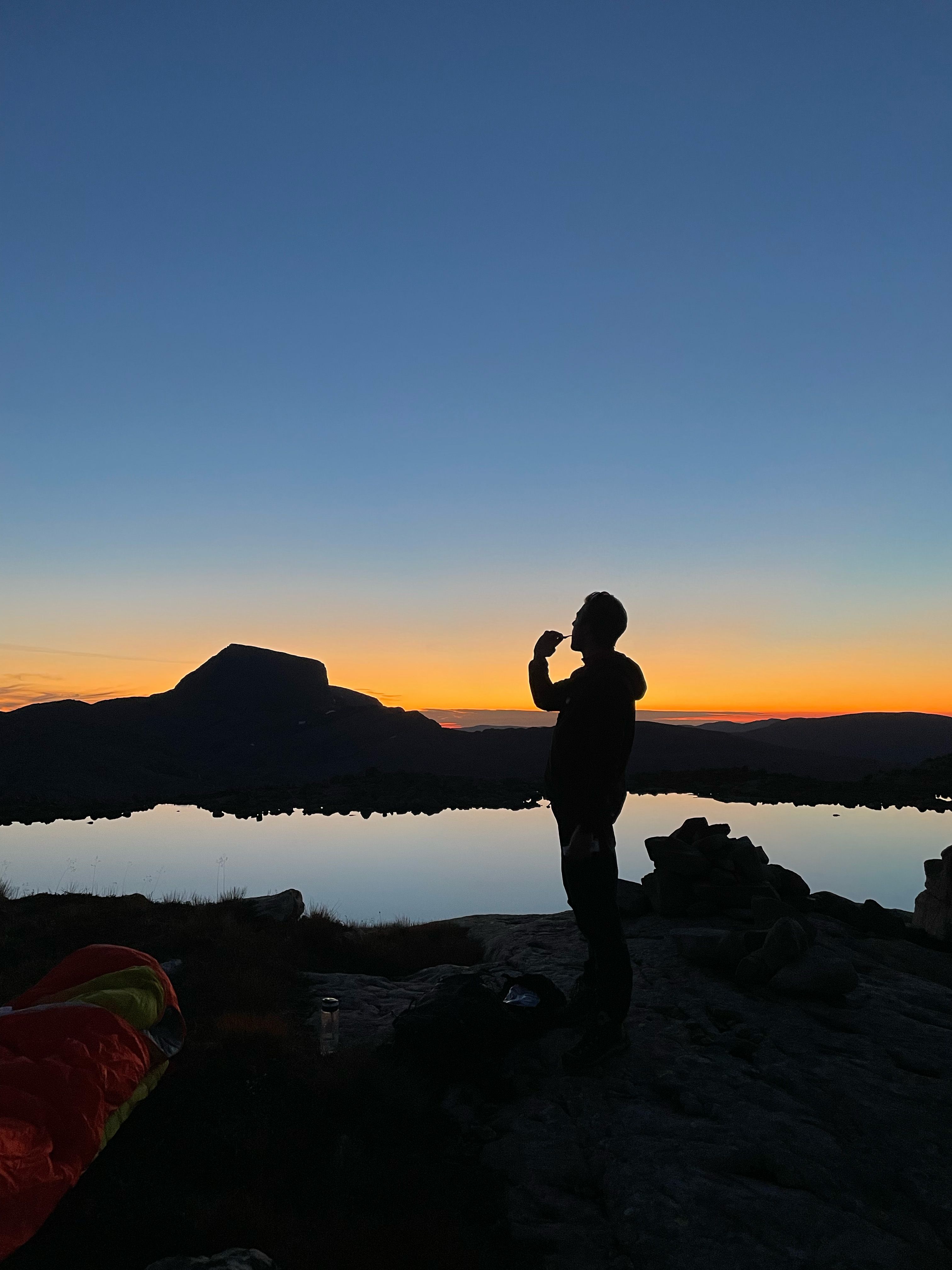A man brushing his teeth in the sunset in Ålfoten, Nordfjord