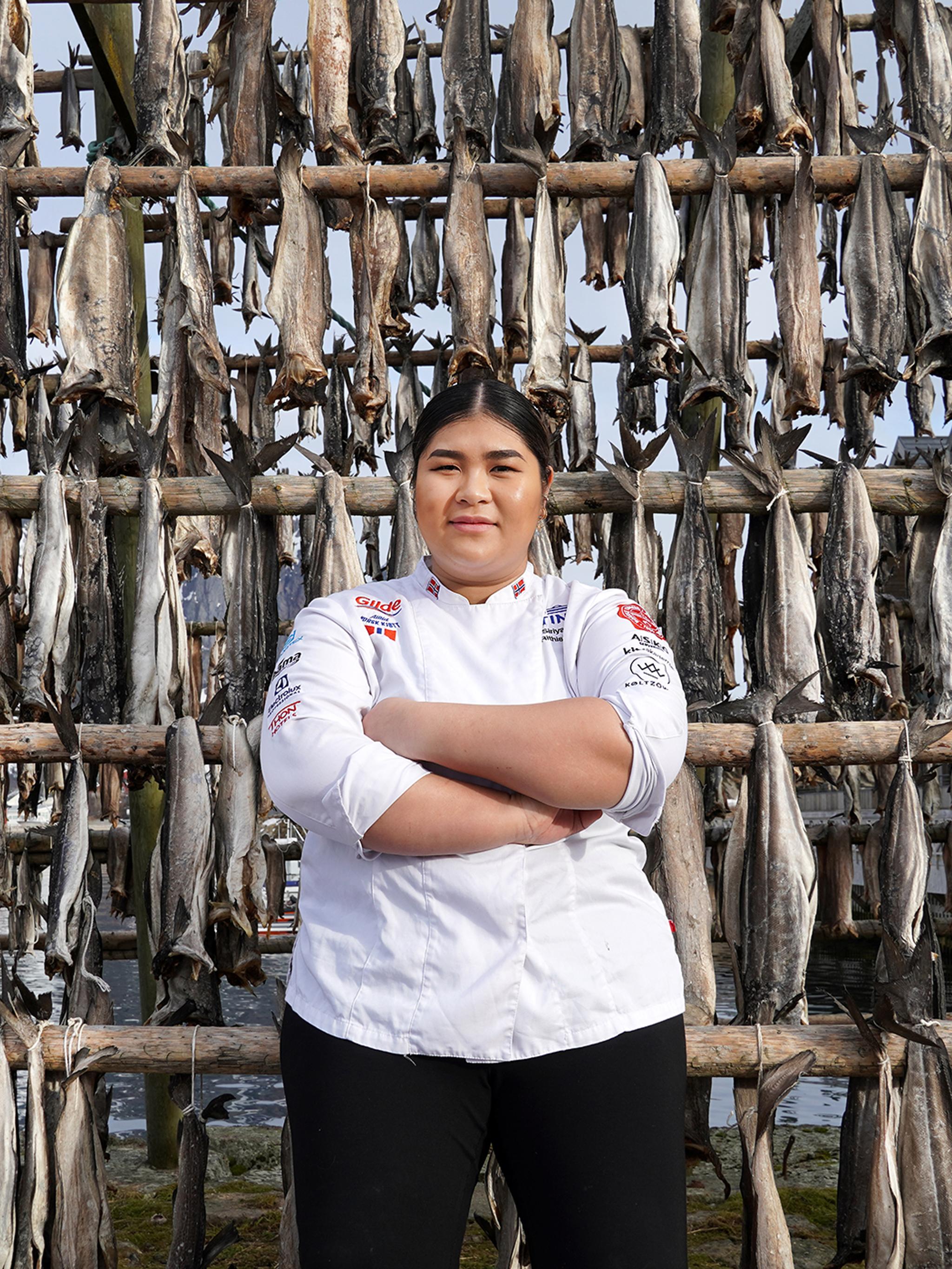 Young woman in front of pollock stockfish.