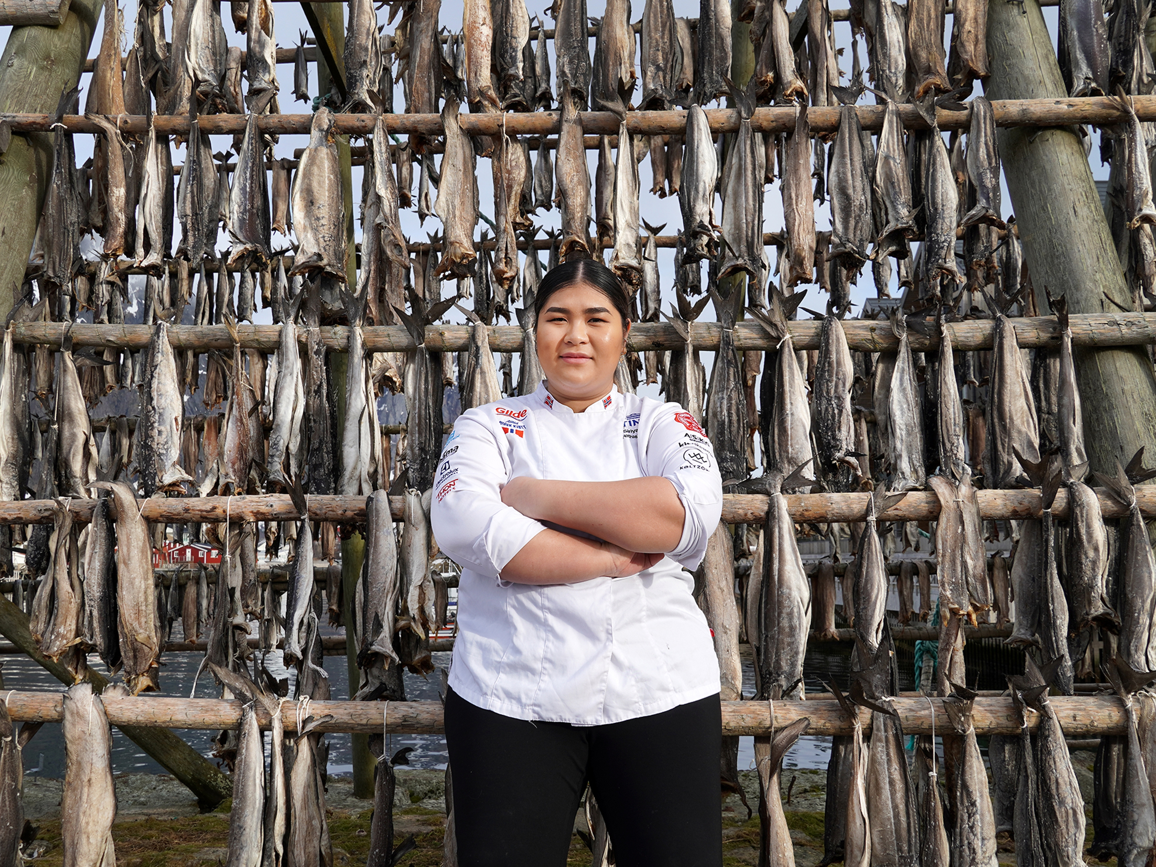 Young woman in front of pollock stockfish.