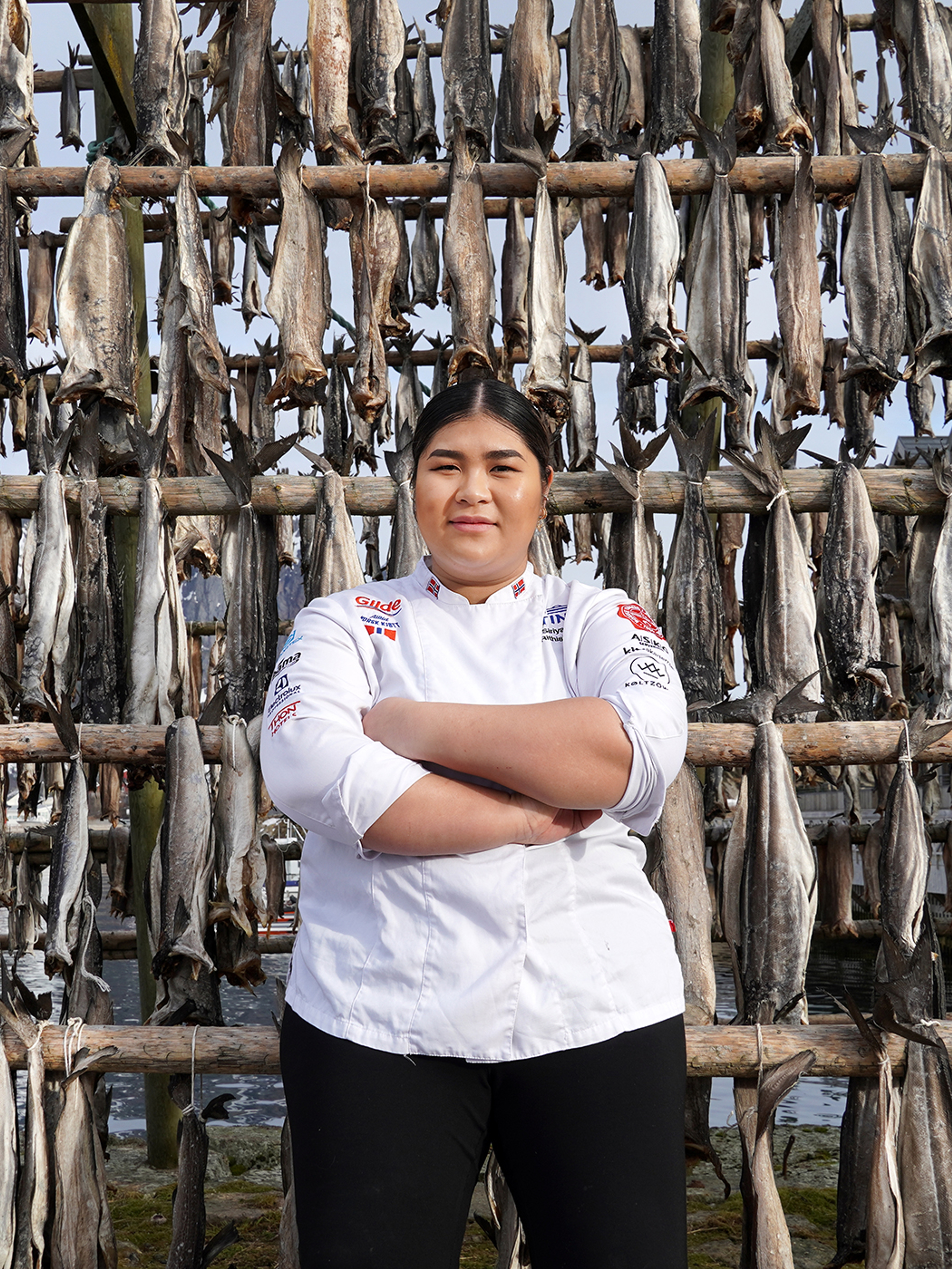 Young woman in front of pollock stockfish.