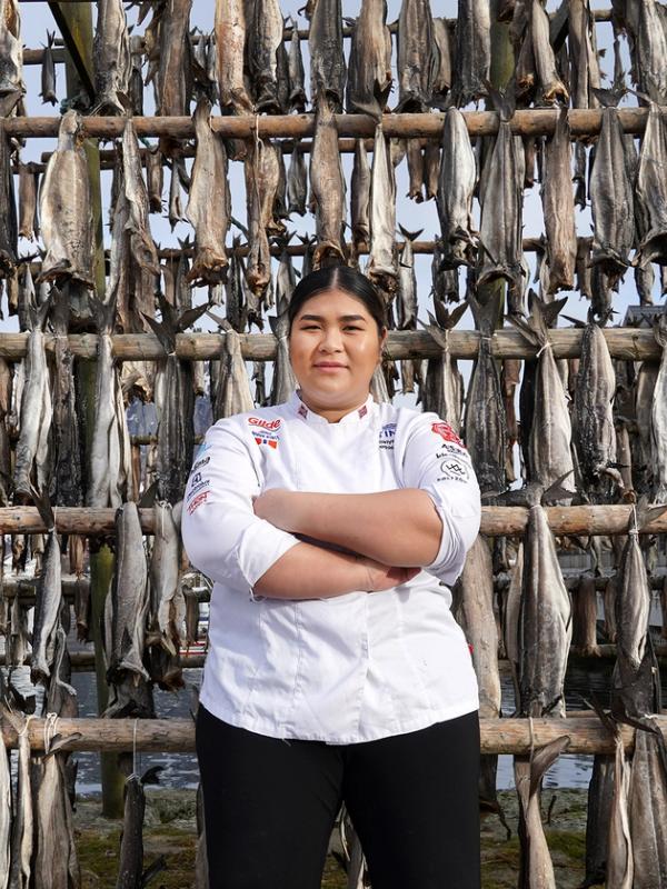 Young woman in front of pollock stockfish.