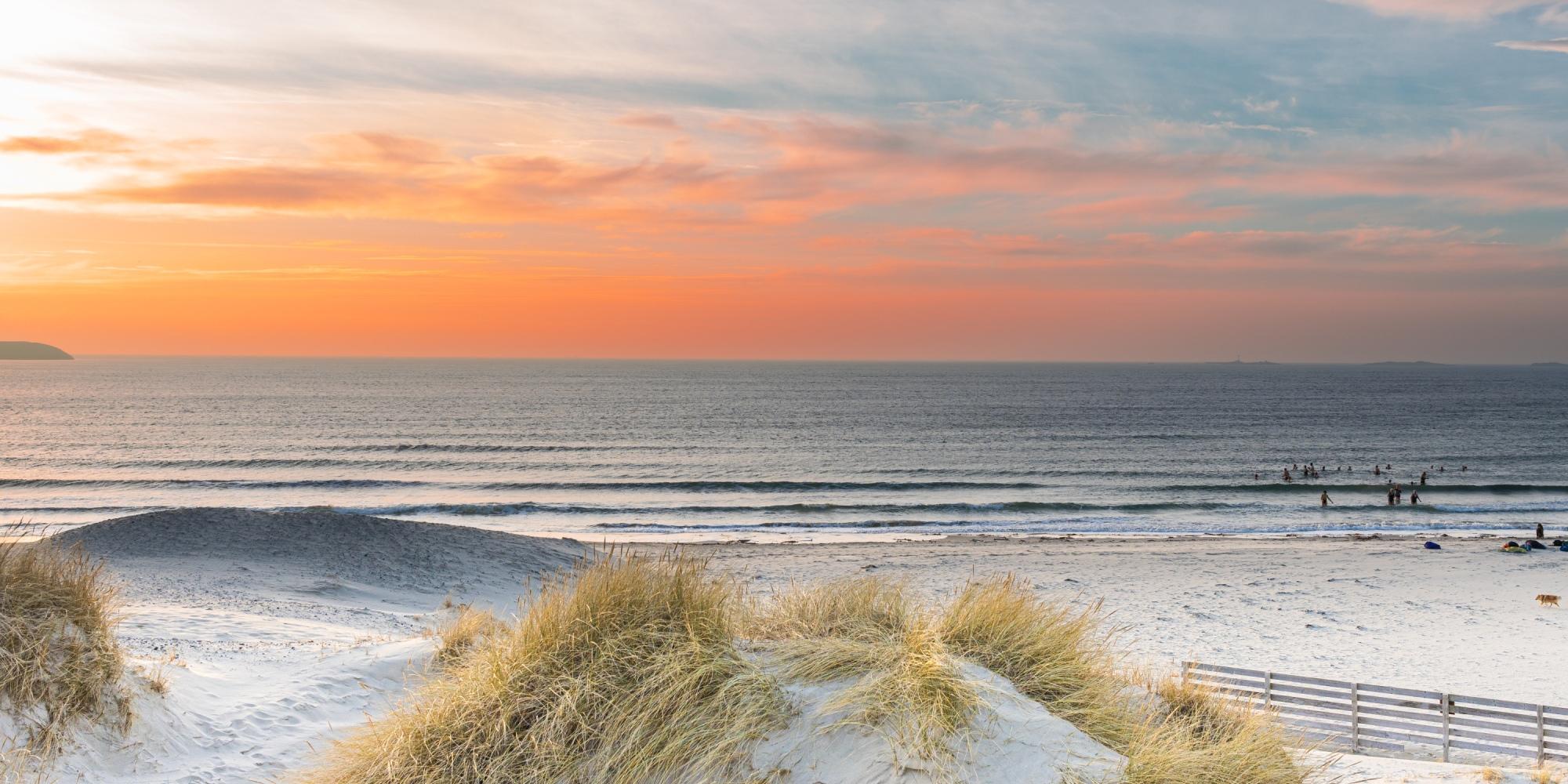 A group of people taking a bath at Solastranden, Sola Beach, in Stavanger