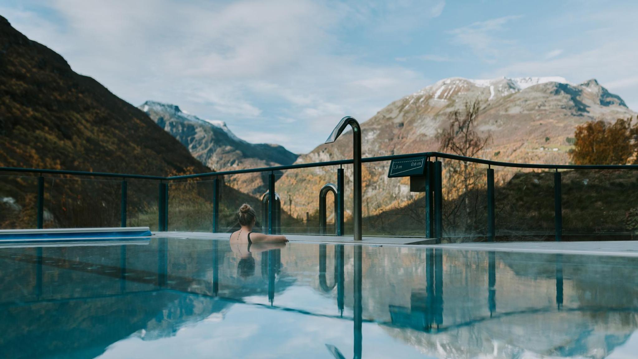 Women relaxing in a pool with a nature view