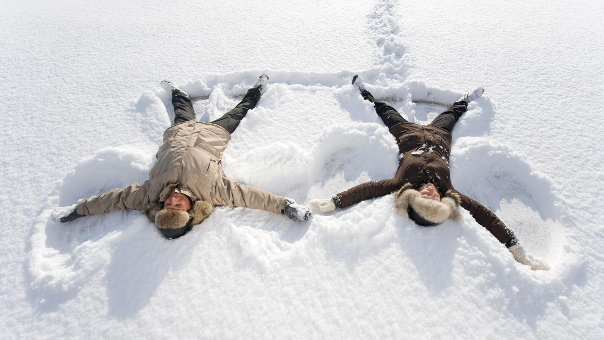 Two people playing in the snow in Finnmark in Northern Norway