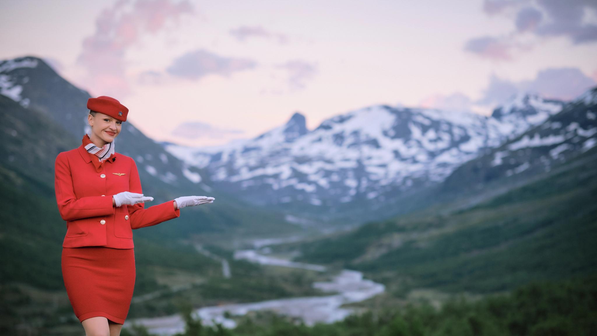 A flight attendant showing off the mountain view in Norway
