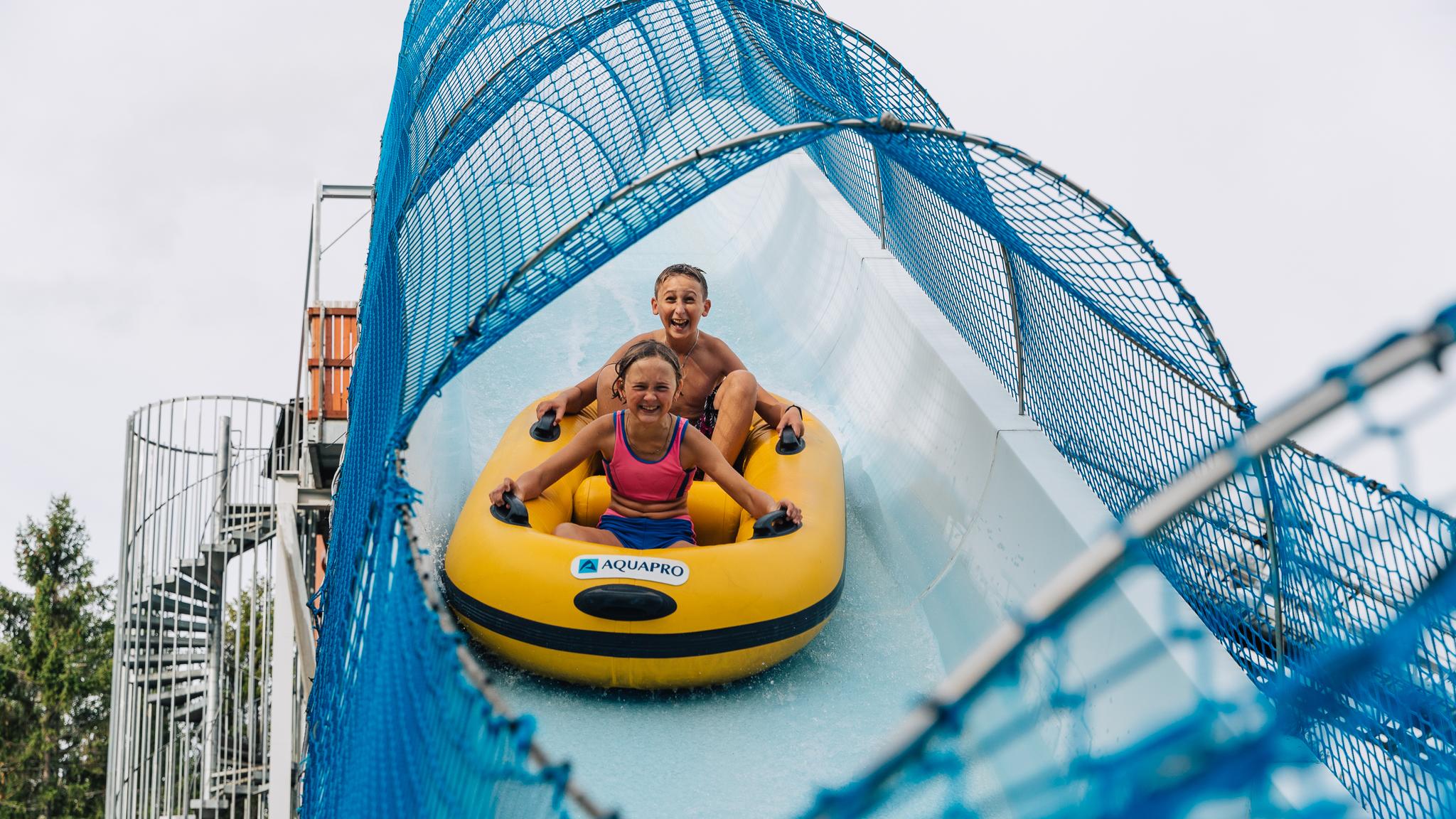 Two children in a water slide at Bø Sommarland waterpark in Telemark, Eastern Norway