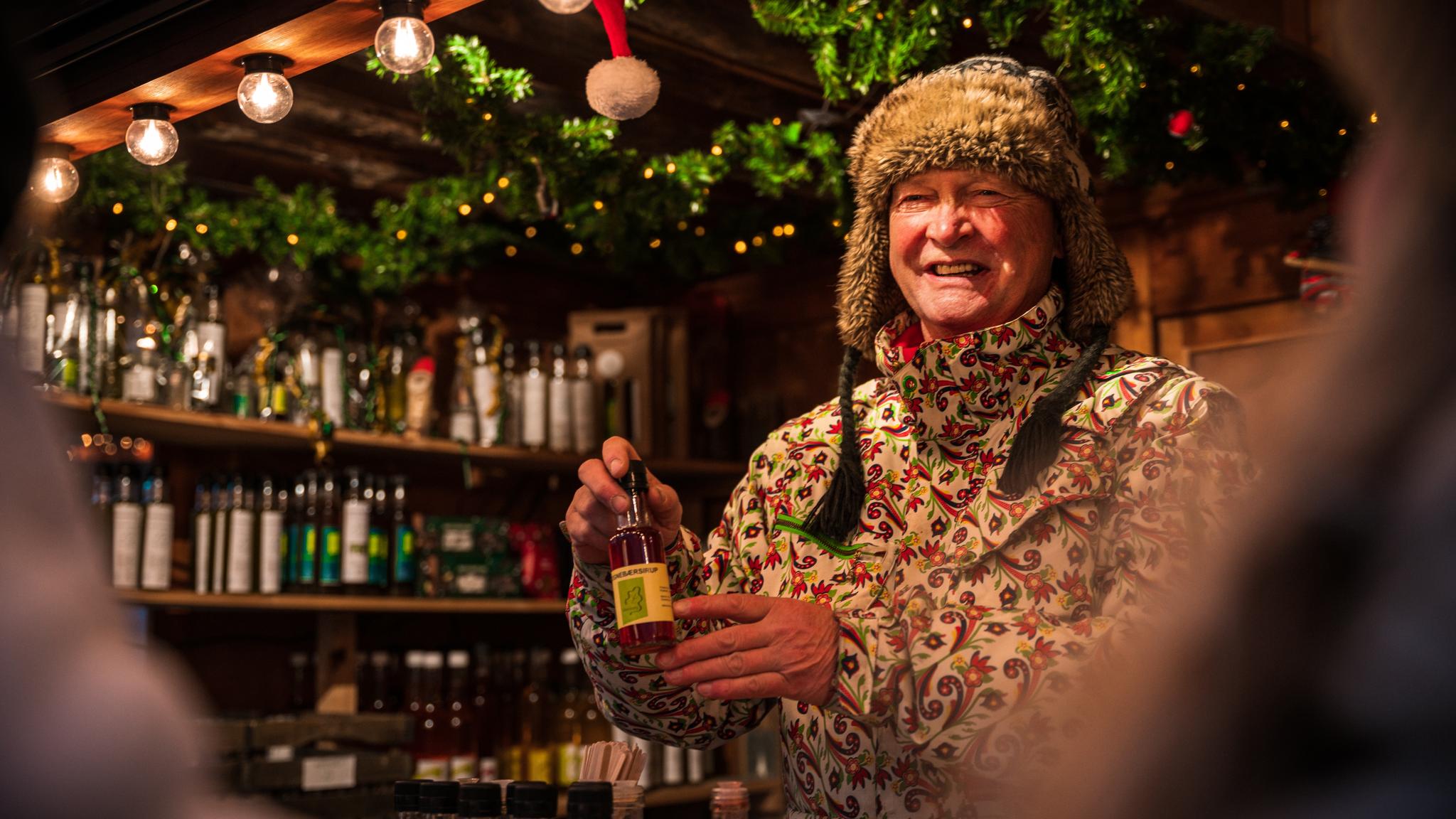 A man selling christmas gifts at a market in Bergen, Fjord Norway