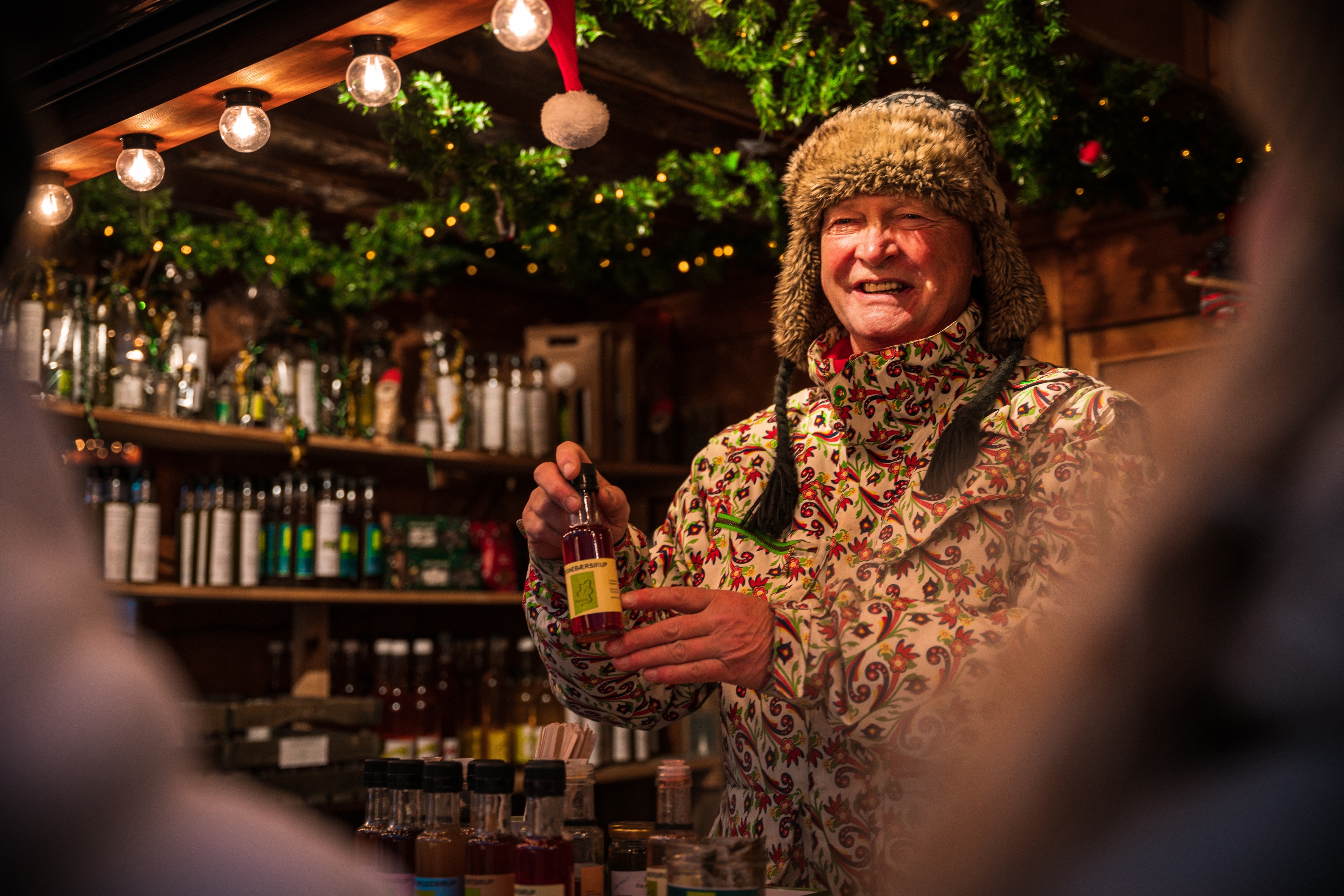 A man selling christmas gifts at a market in Bergen, Fjord Norway