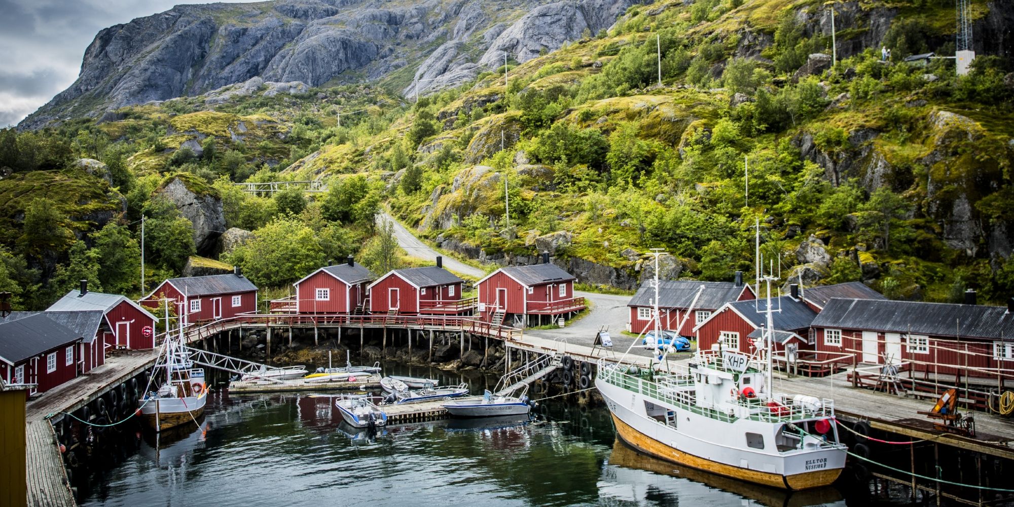 Boats and red fisherman's cabins along the small harbour of Nusfjord in Lofoten, Northern Norway