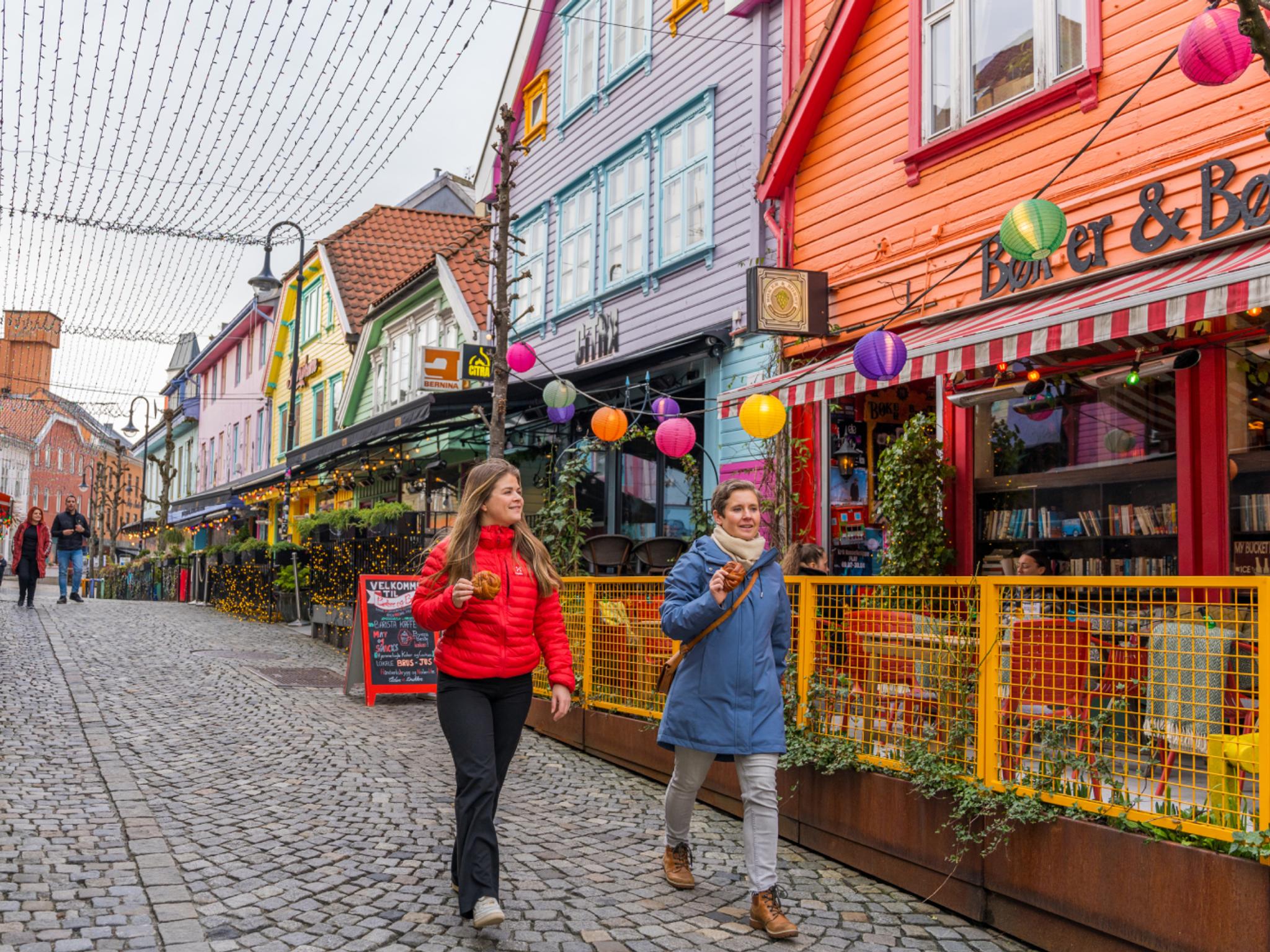 Two friends walking in Fargegaten, The colour street, in Stavanger