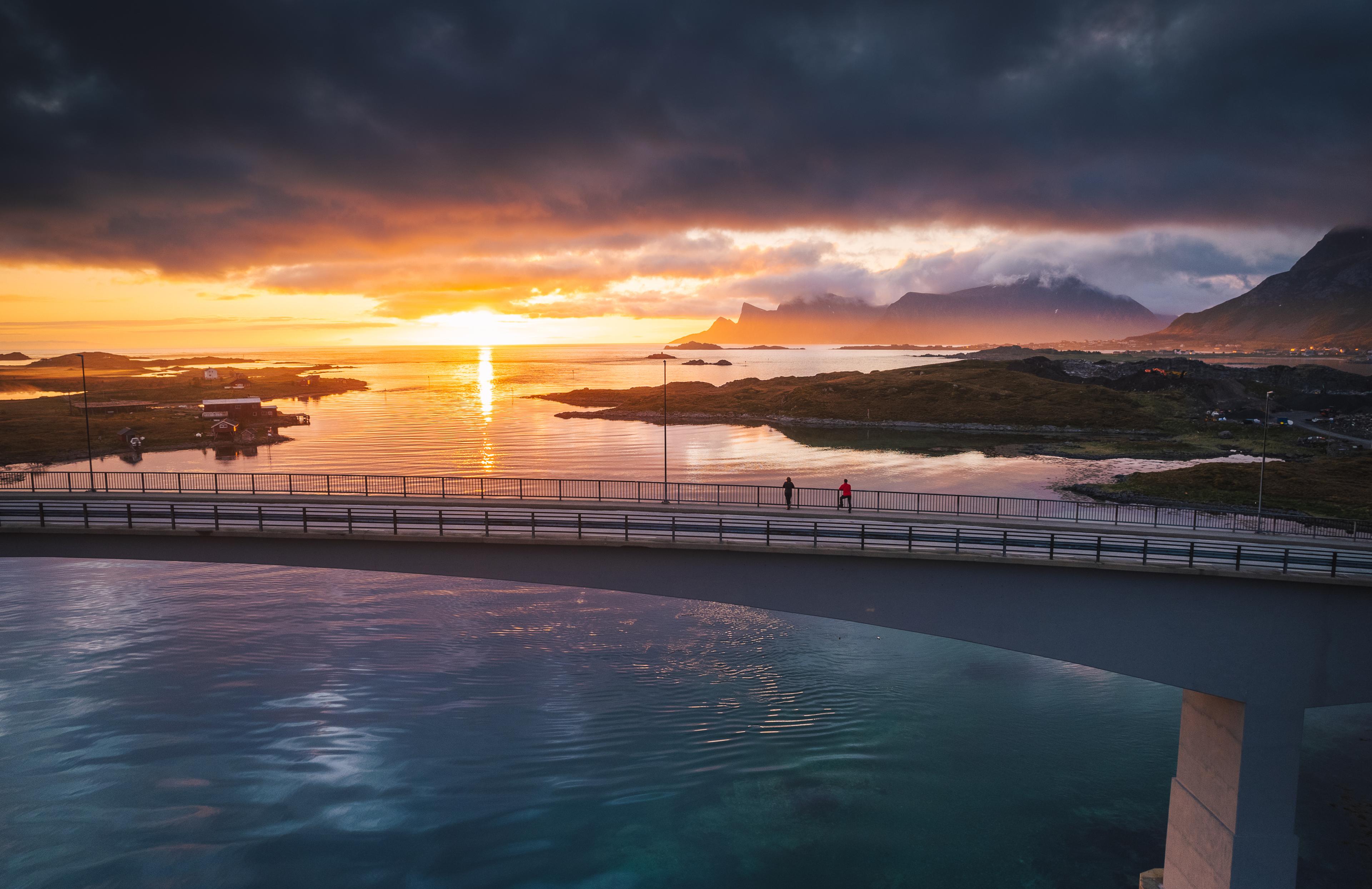 Two people exploring Lofoten under the midnight sun