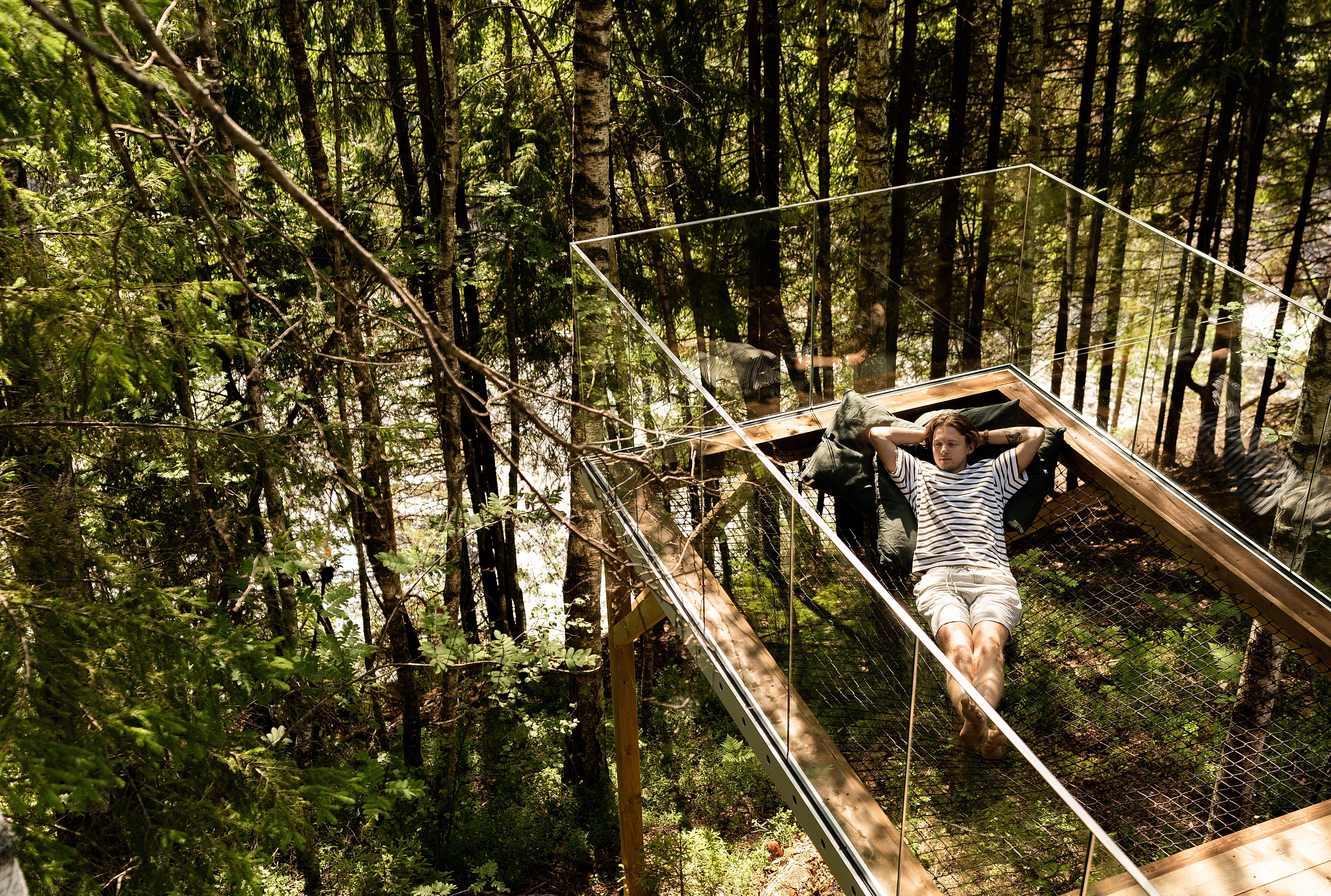 En man som njuter av den fredliga naturen i en trädkoja i Laagen,Larvik