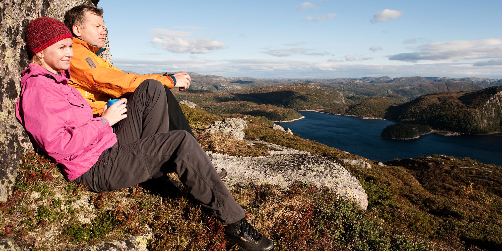 To mennesker sitter og ser på utsikten i Sirdals fjellheim