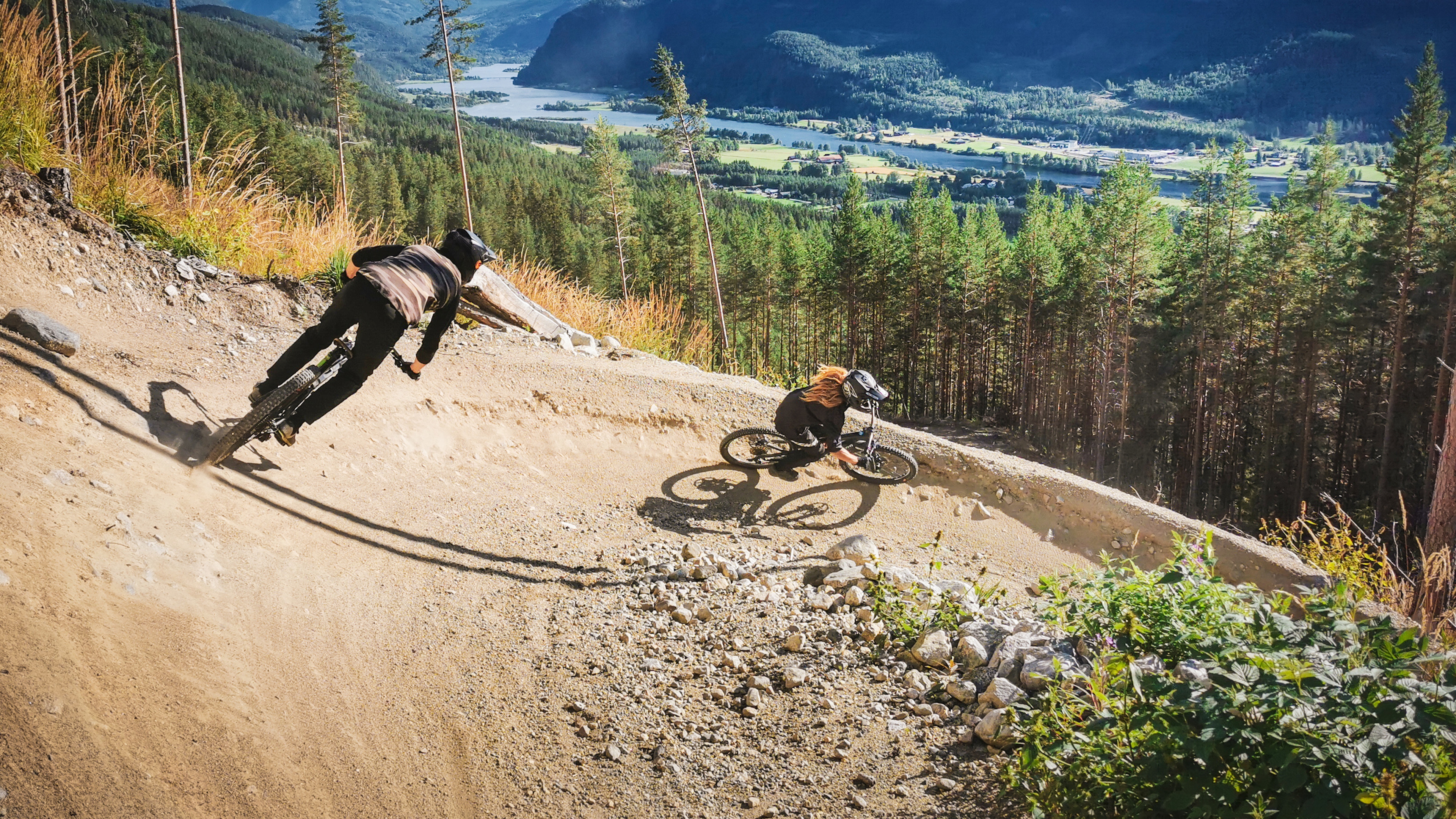 Two people cycling down Den Ravinde in Nesbyen, Eastern Norway.