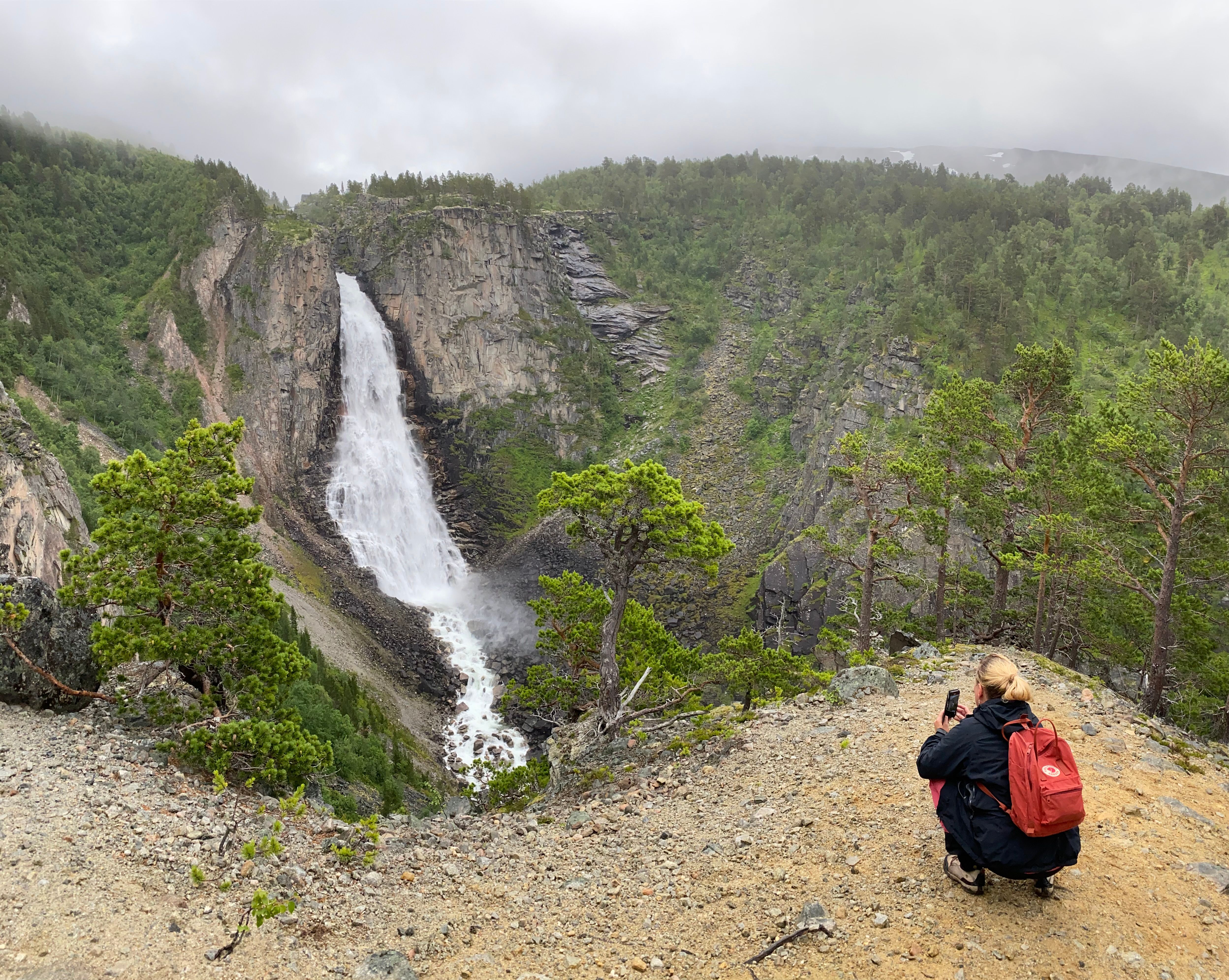 A woman by the Lindisfallet waterfall in Åmotan