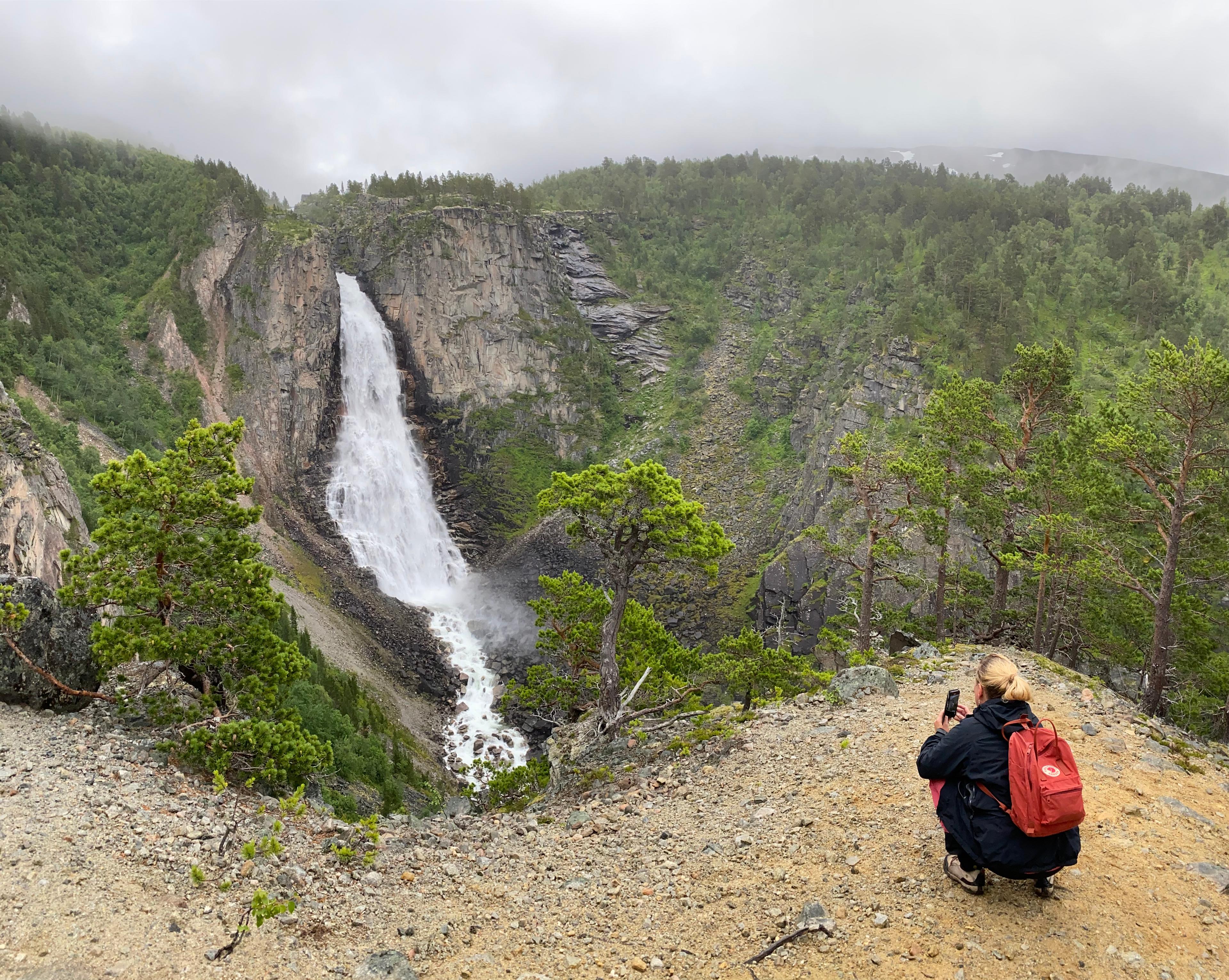 A woman by the Lindisfallet waterfall in Åmotan