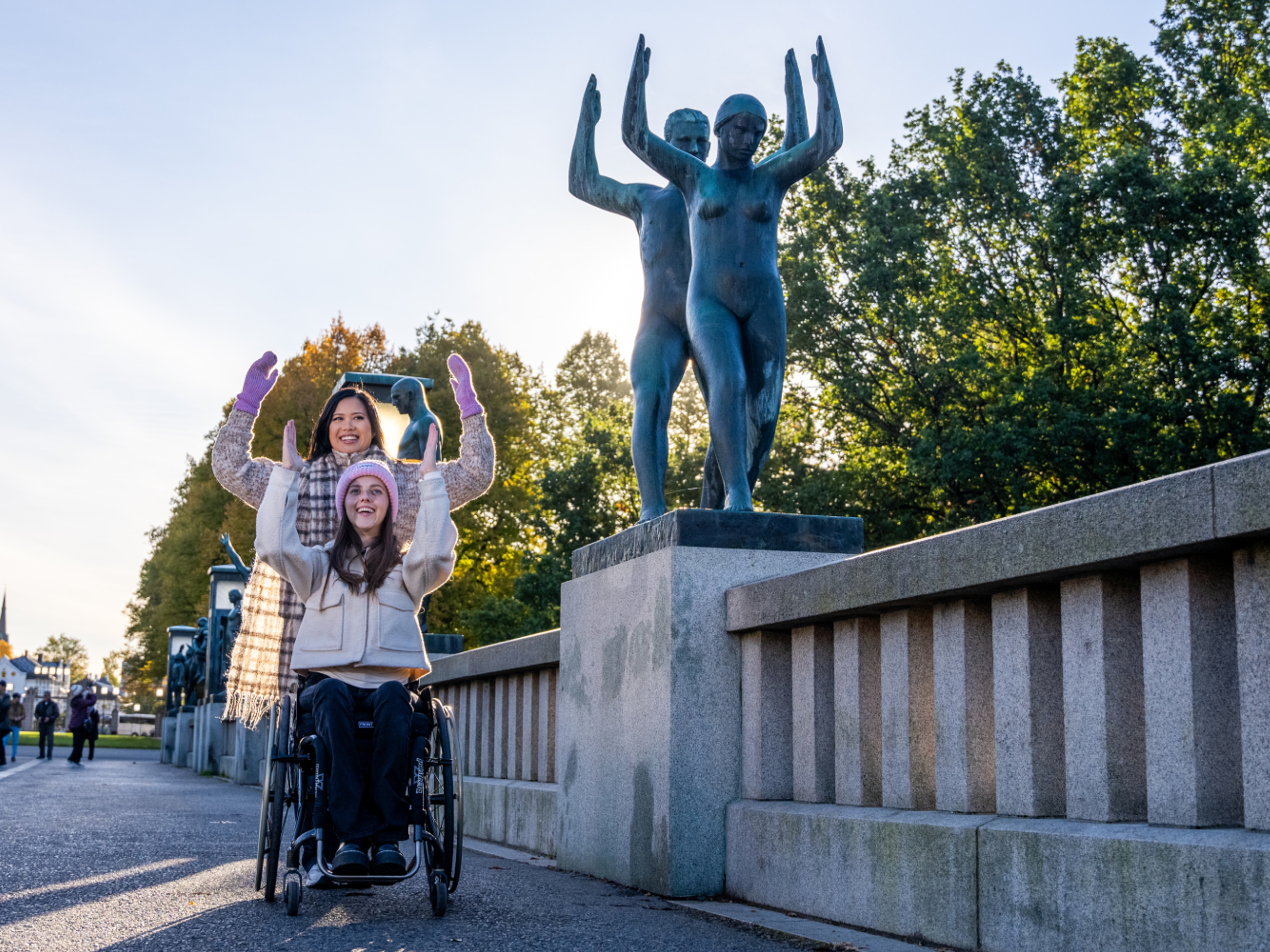 Two women imitating a statue in Vigelandsparken at Frogner in Oslo, Eastern Norway