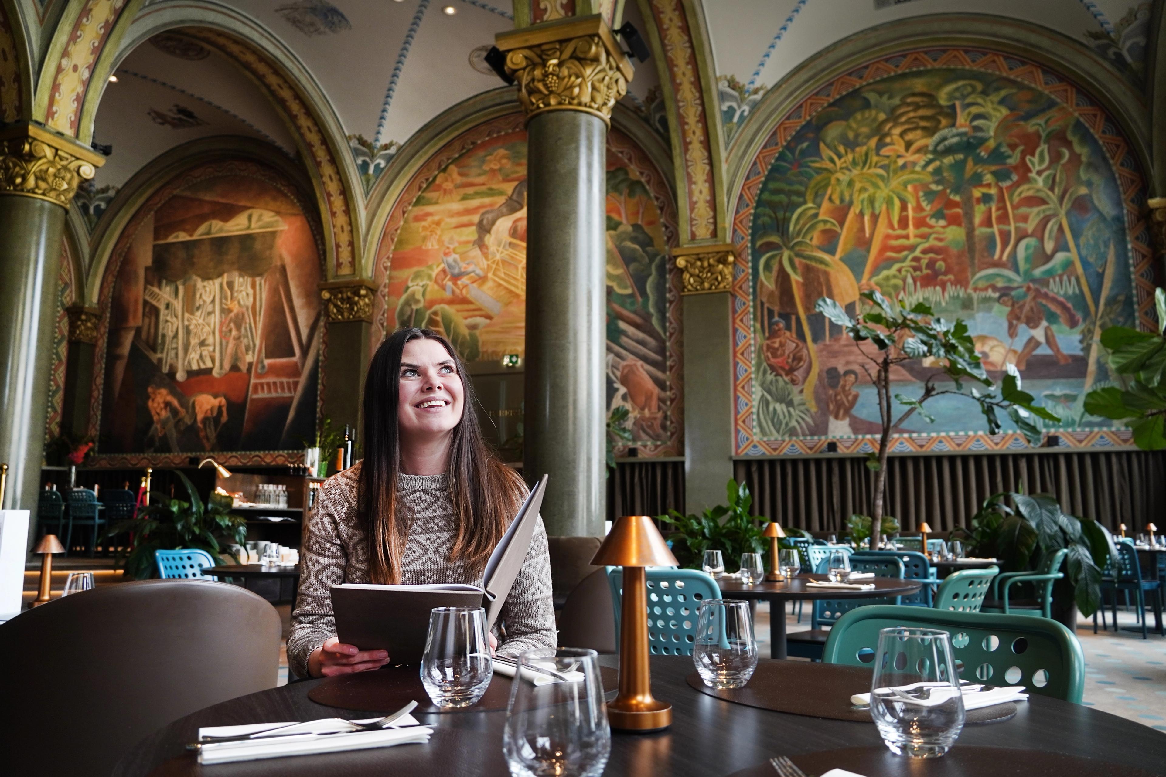 Woman sitting in Frescohallen Restaurant - Bergen Børs Hotel