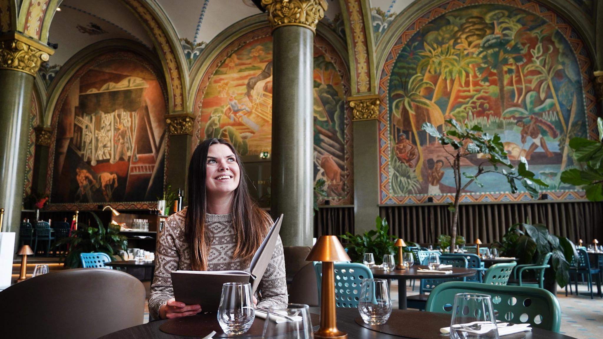 Woman sitting in Frescohallen Restaurant - Bergen Børs Hotel
