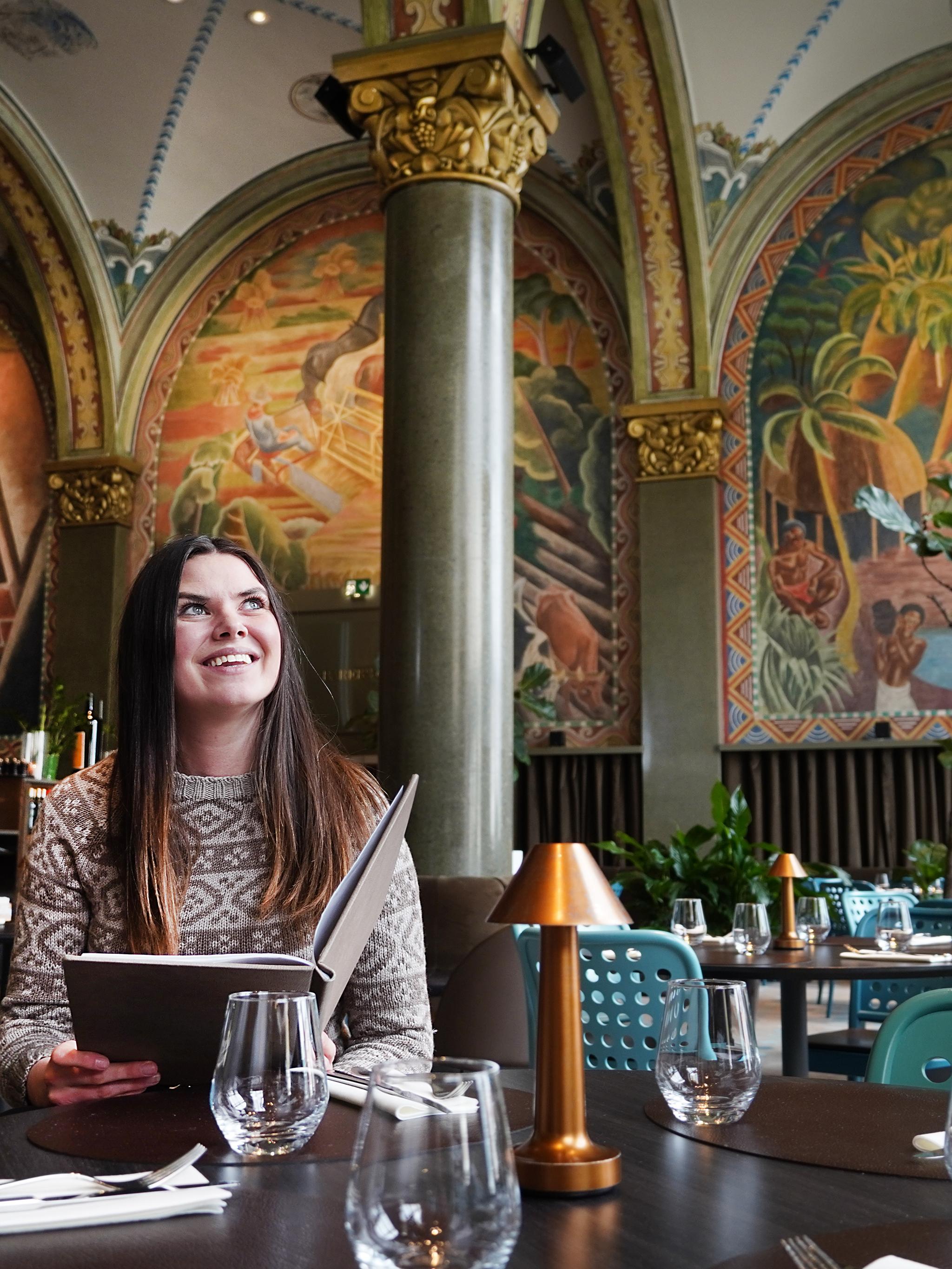 Woman sitting in Frescohallen Restaurant - Bergen Børs Hotel