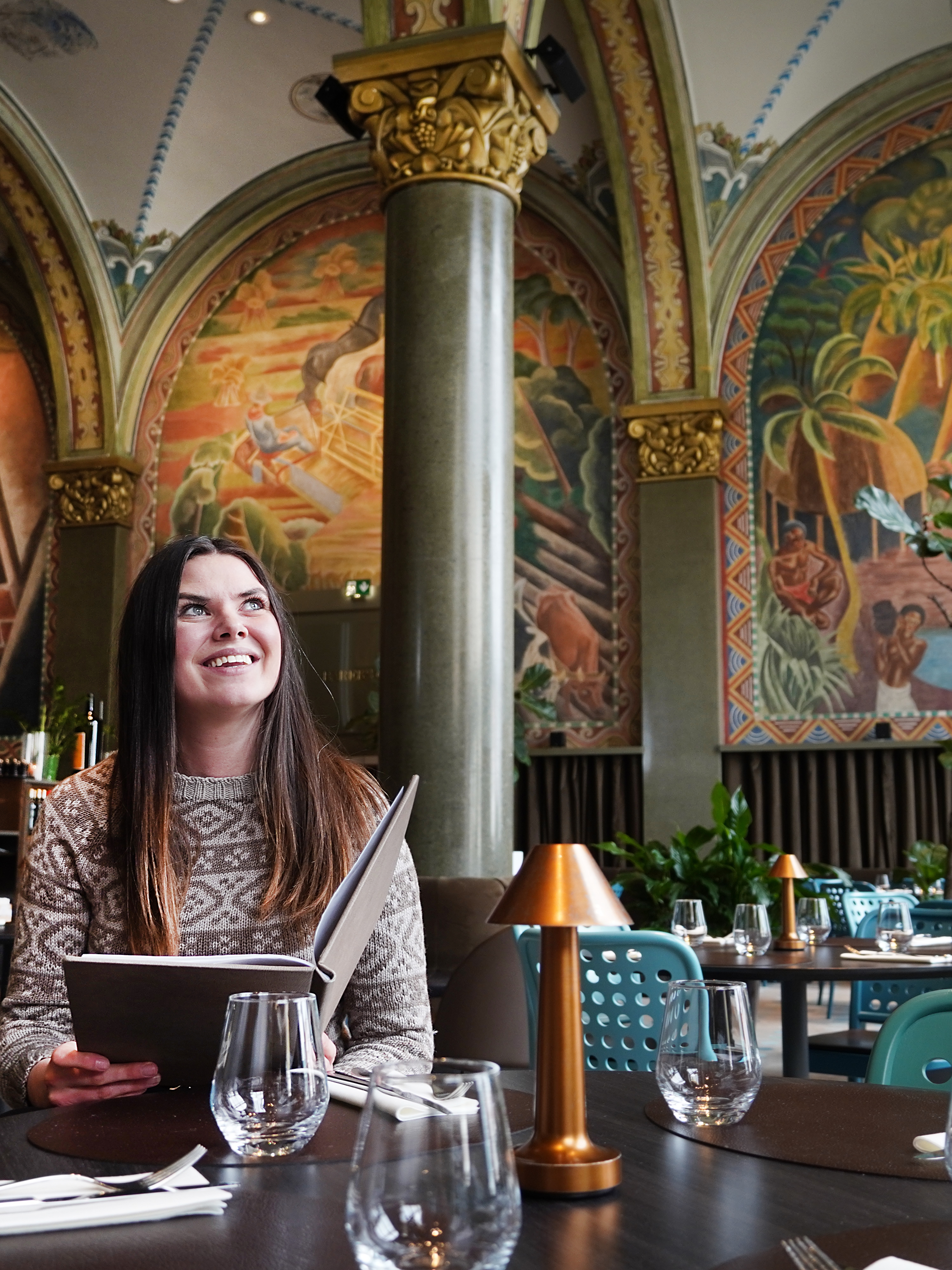 Woman sitting in Frescohallen Restaurant - Bergen Børs Hotel