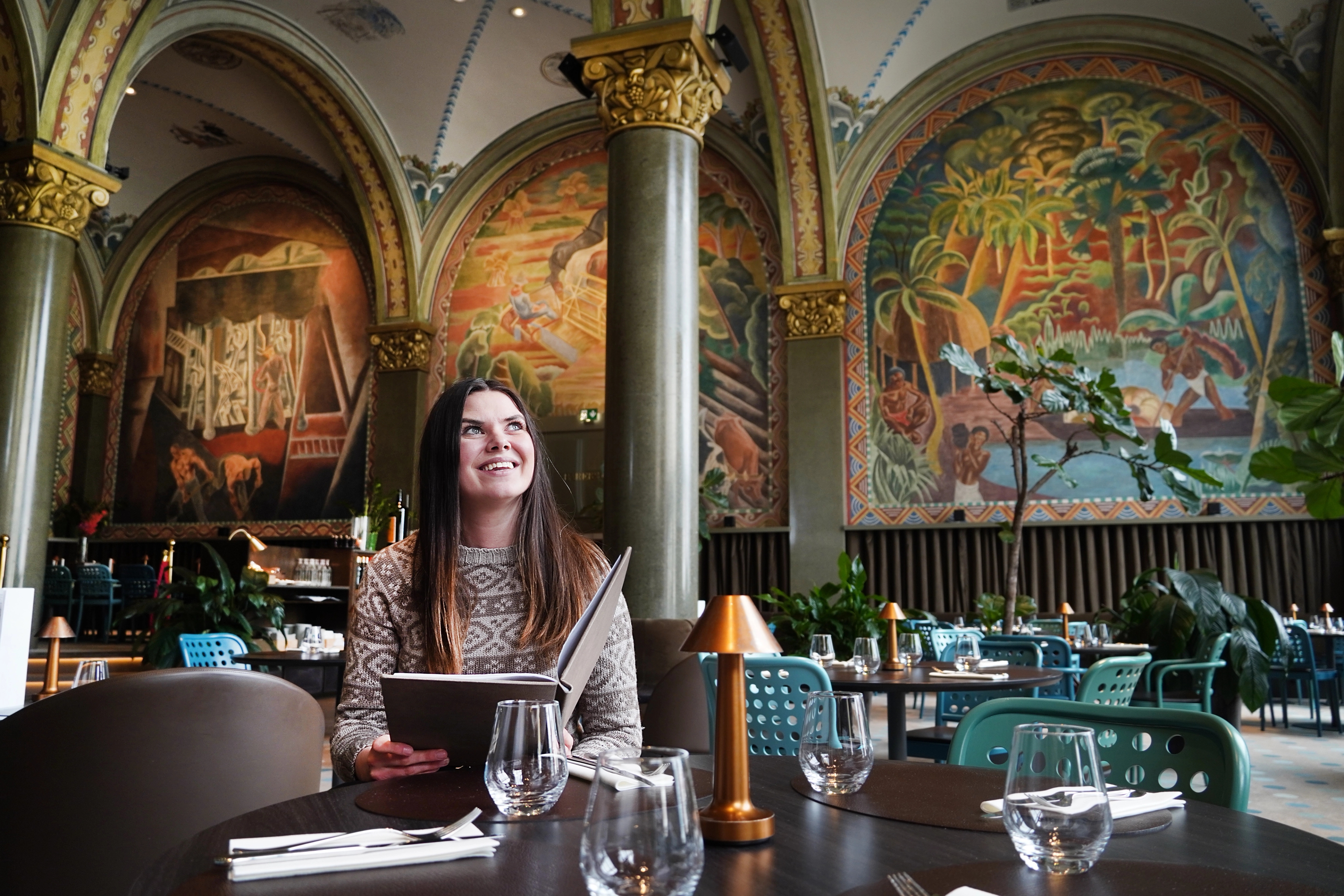 Woman sitting in Frescohallen Restaurant - Bergen Børs Hotel