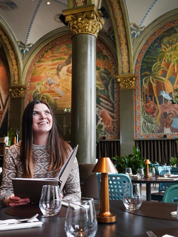 Woman sitting in Frescohallen Restaurant - Bergen Børs Hotel
