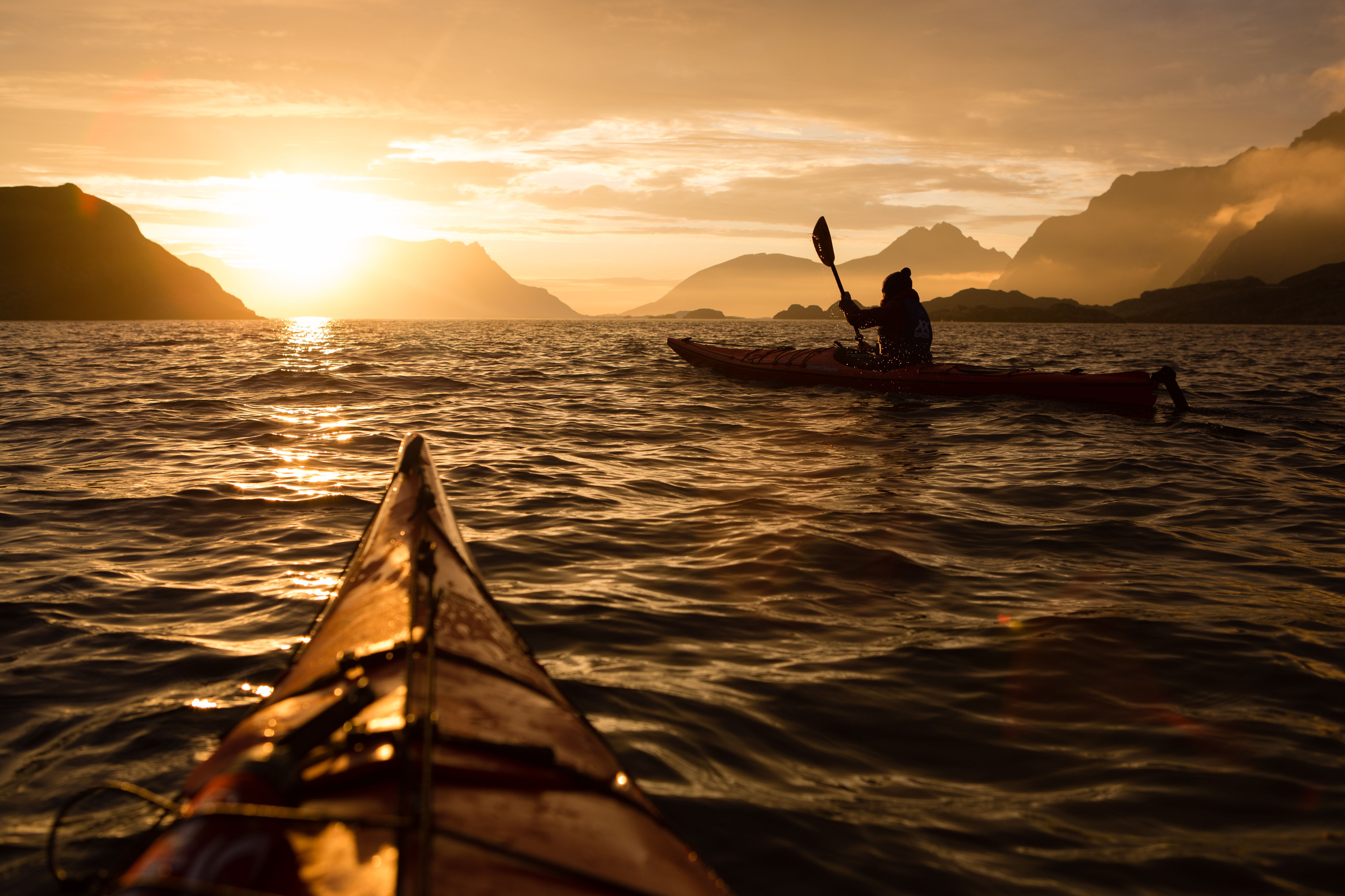 Kayaking under the midnight sun near Lofoten, Northern Norway
