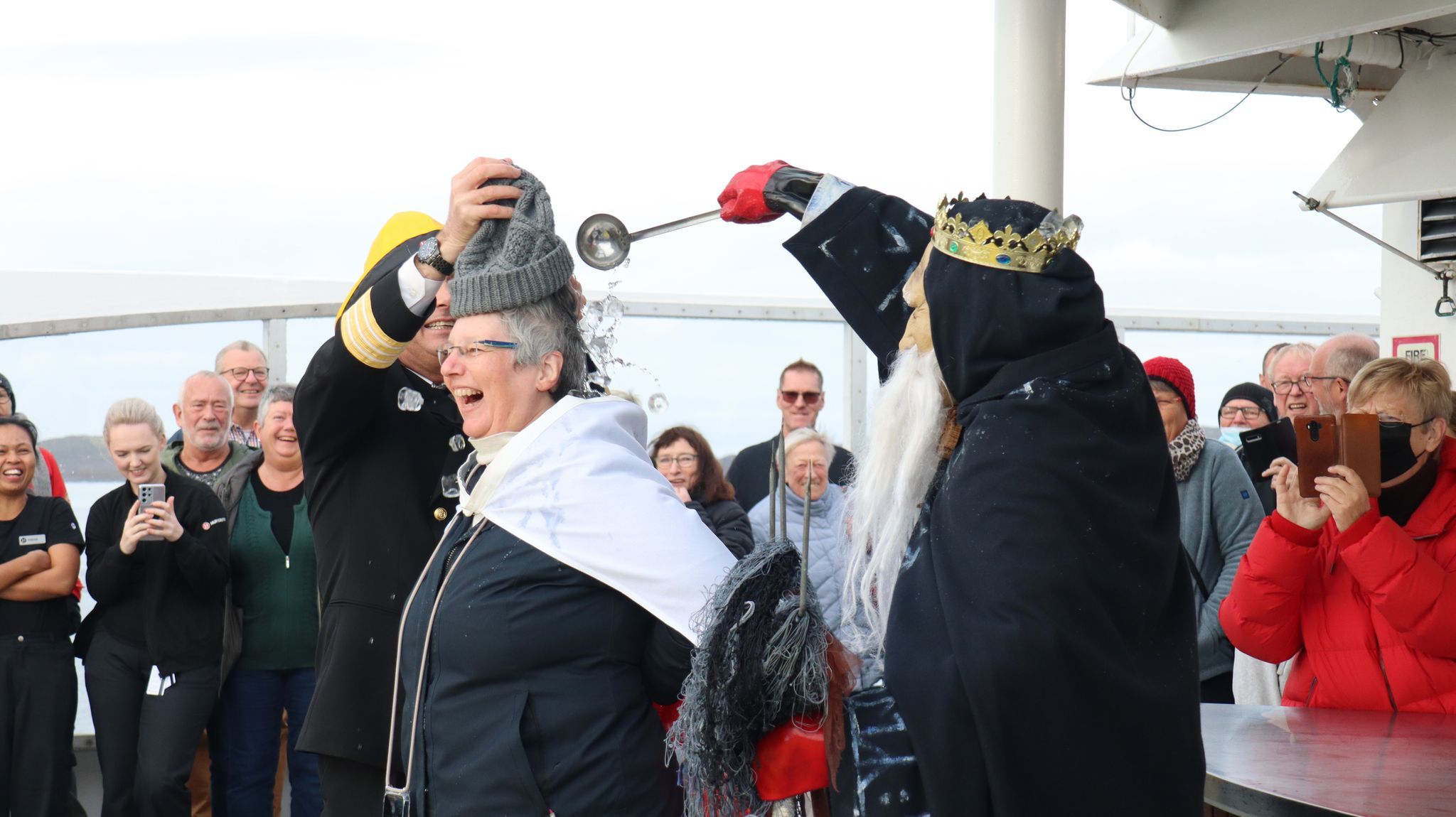 A women celebrates crossing the Arctic Circle with Hurtigruten, Norway.