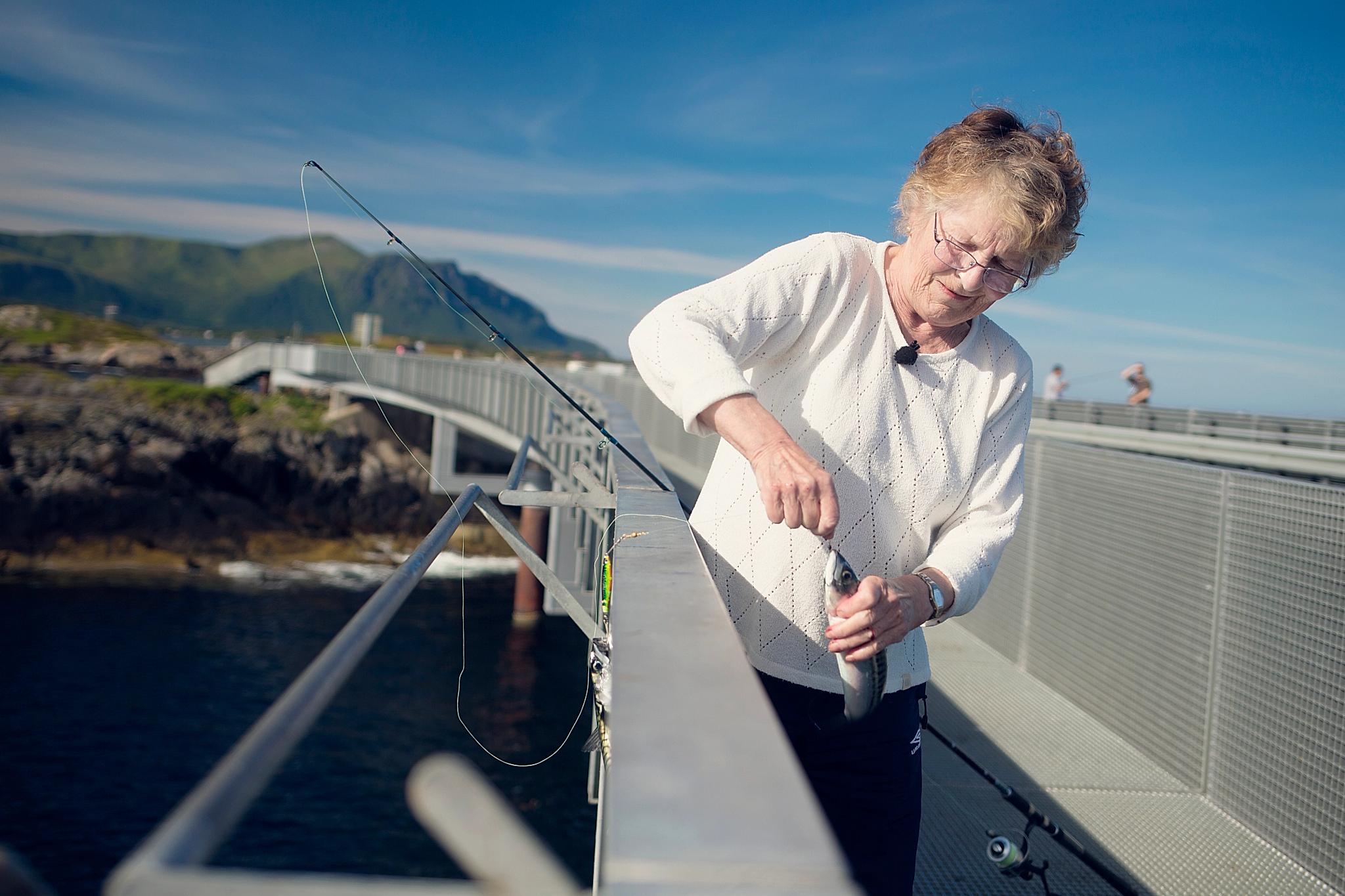 Olgunn Johansen is fishing at Atlanterhavsvegen in Northwest, Fjord Norway