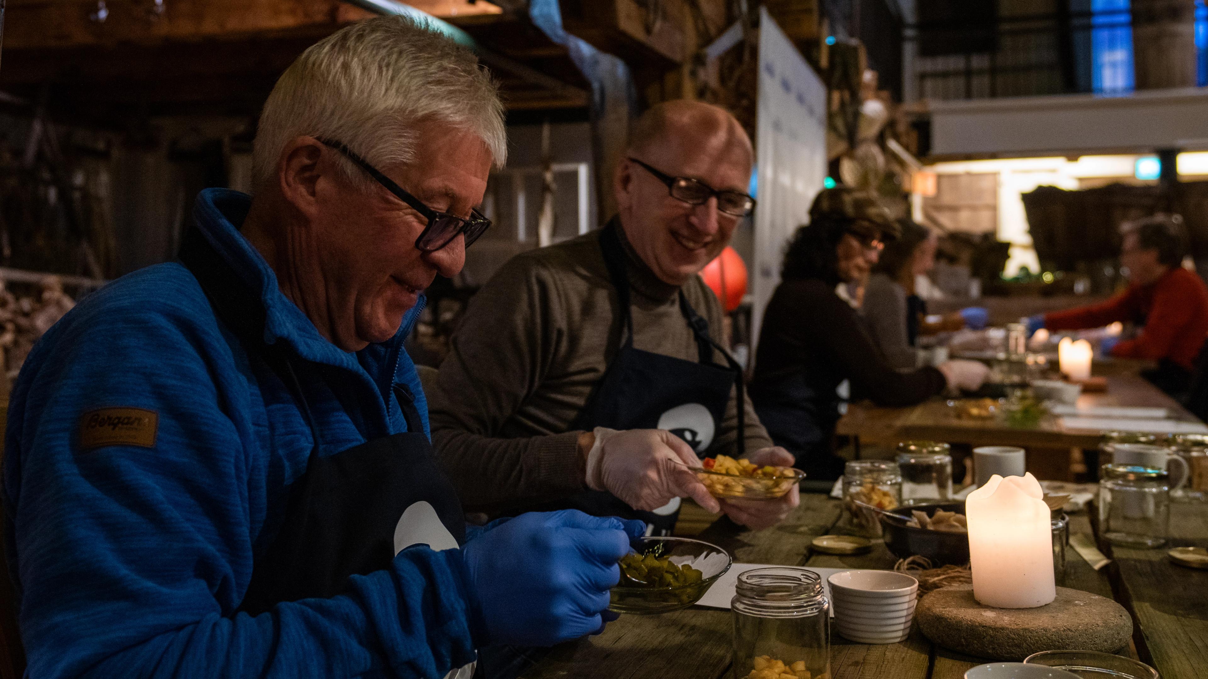 People making traditional Norwegian pickled herring