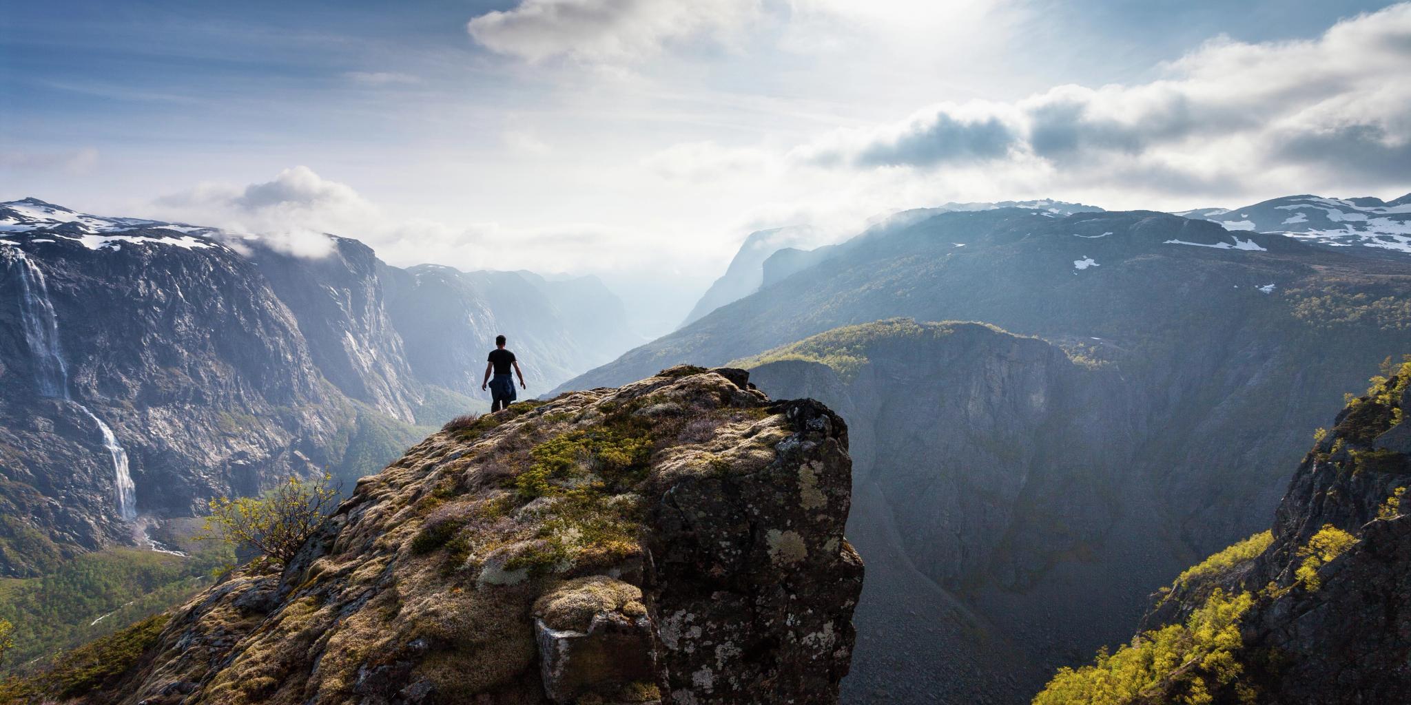 Man hiking the mountain Fossdjuvet in Forsand, Fjord Norway