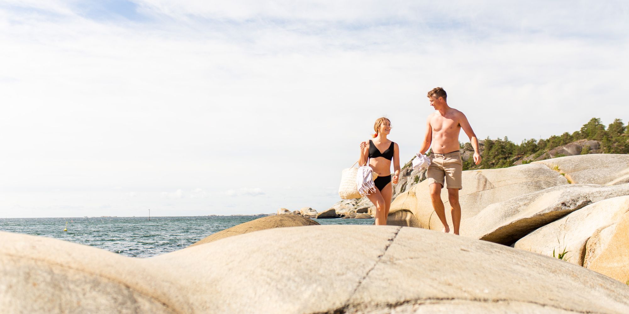 Couple enjoying the sun at Ula Beach in Larvik