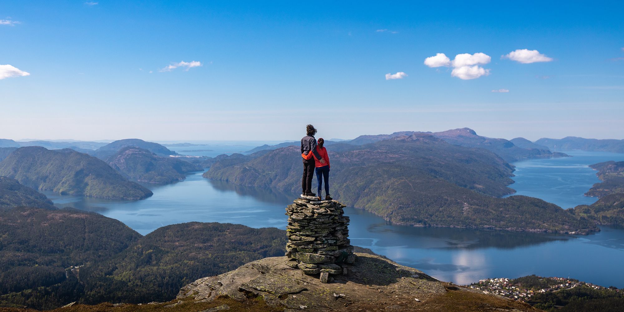 A couple on a mountain top with fjord view in Suldal in Ryfylke, Fjord Norway